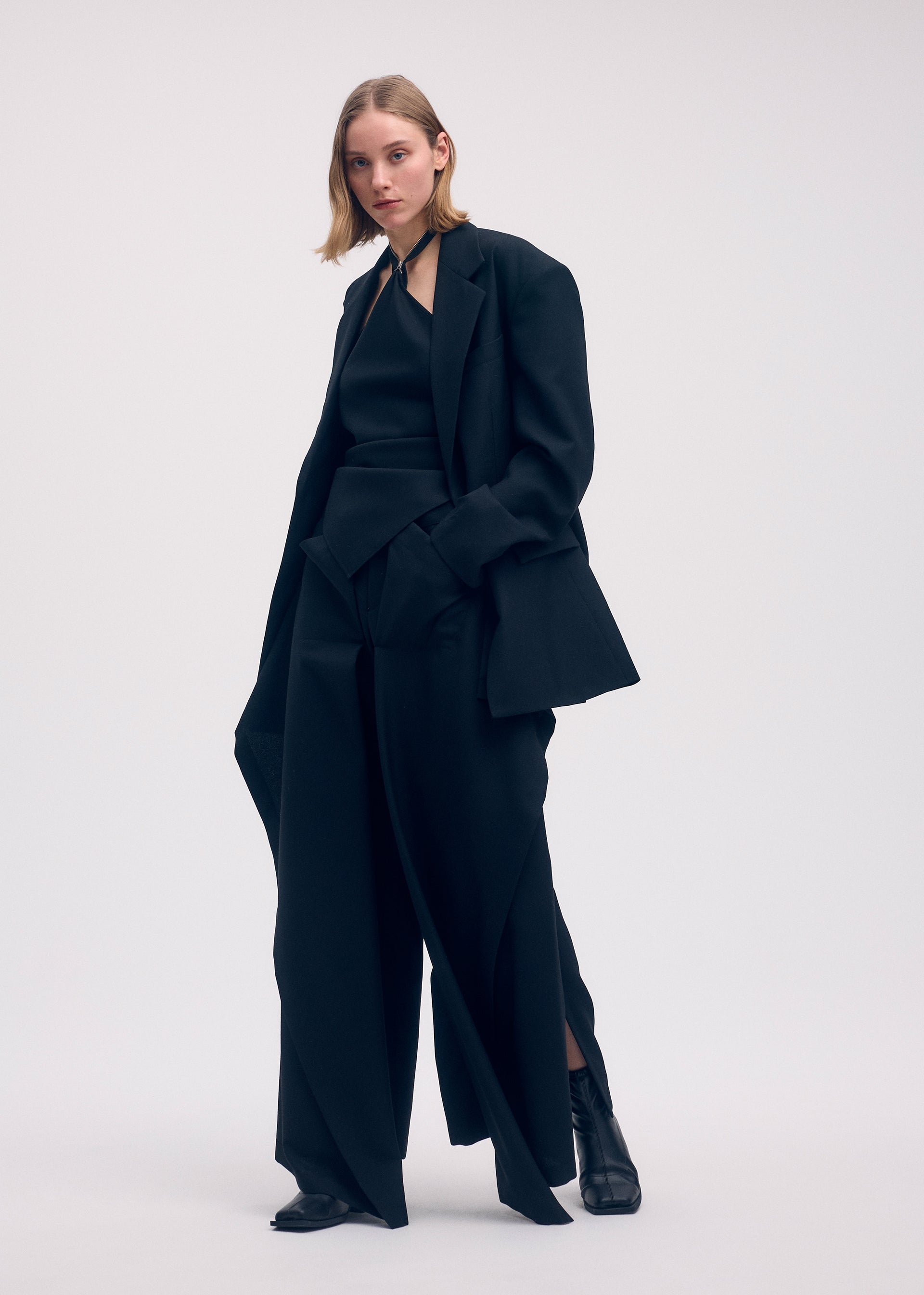 A model wears the ISSEY MIYAKE UNI FORM (WOOL) shirt.