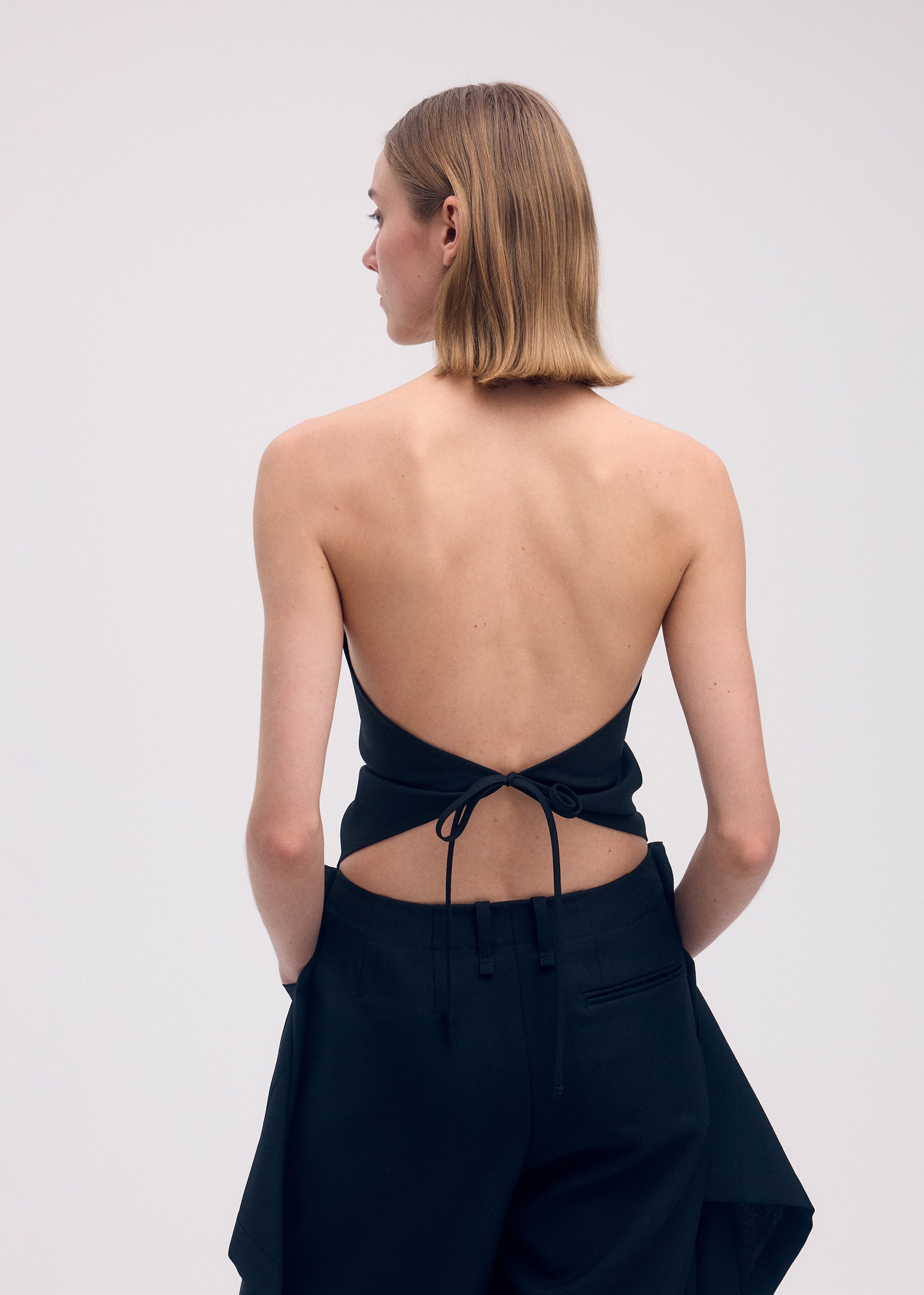 A model wears the ISSEY MIYAKE UNI FORM (WOOL) shirt.