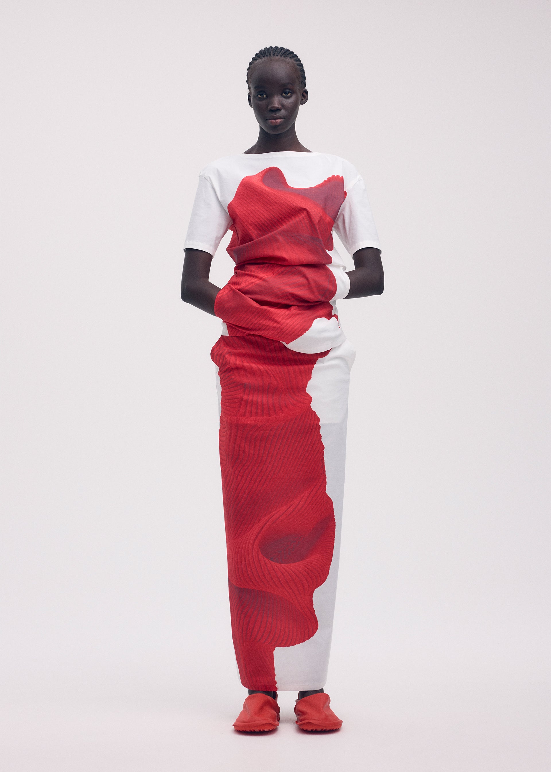A model wears the ISSEY MIYAKE KNIT (AS REPRESENTED) shirt.
