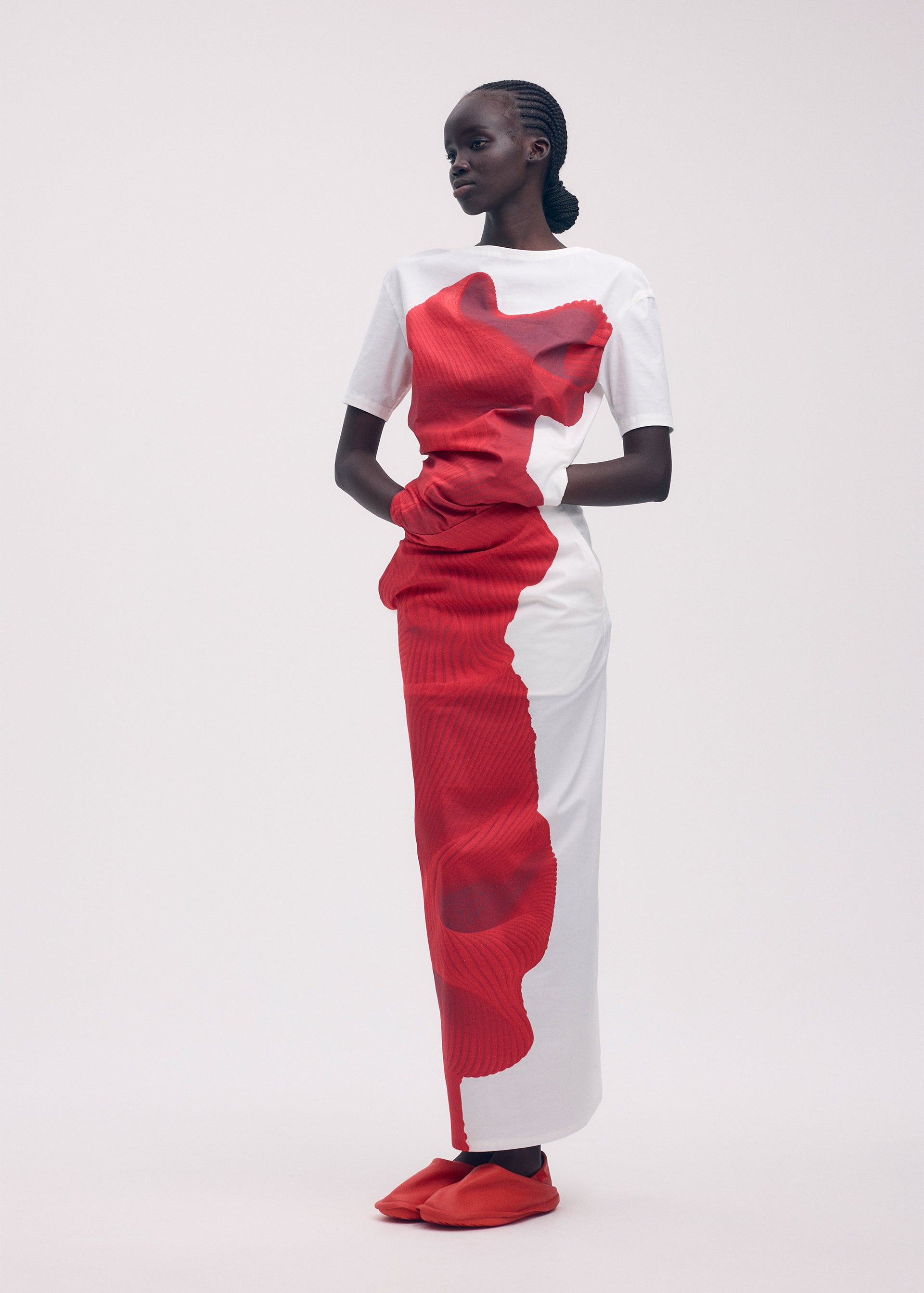 A model wears the ISSEY MIYAKE KNIT (AS REPRESENTED) shirt.