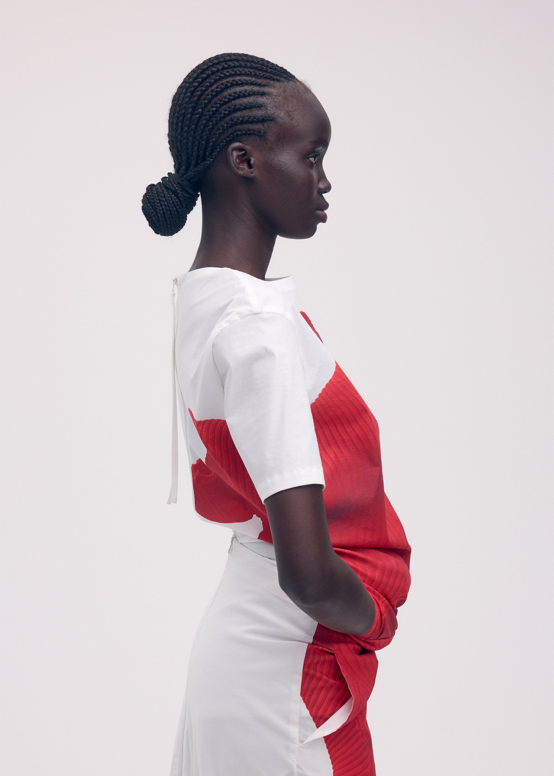 A model wears the ISSEY MIYAKE KNIT (AS REPRESENTED) shirt.
