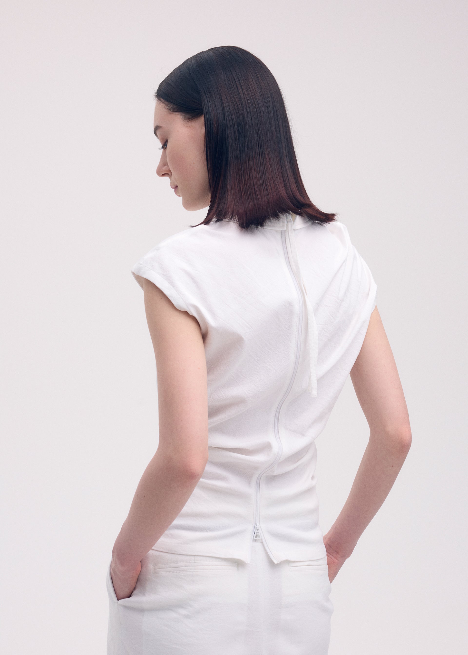 A model wears the ISSEY MIYAKE LIKE TORSO LIKE SHIRT shirt.