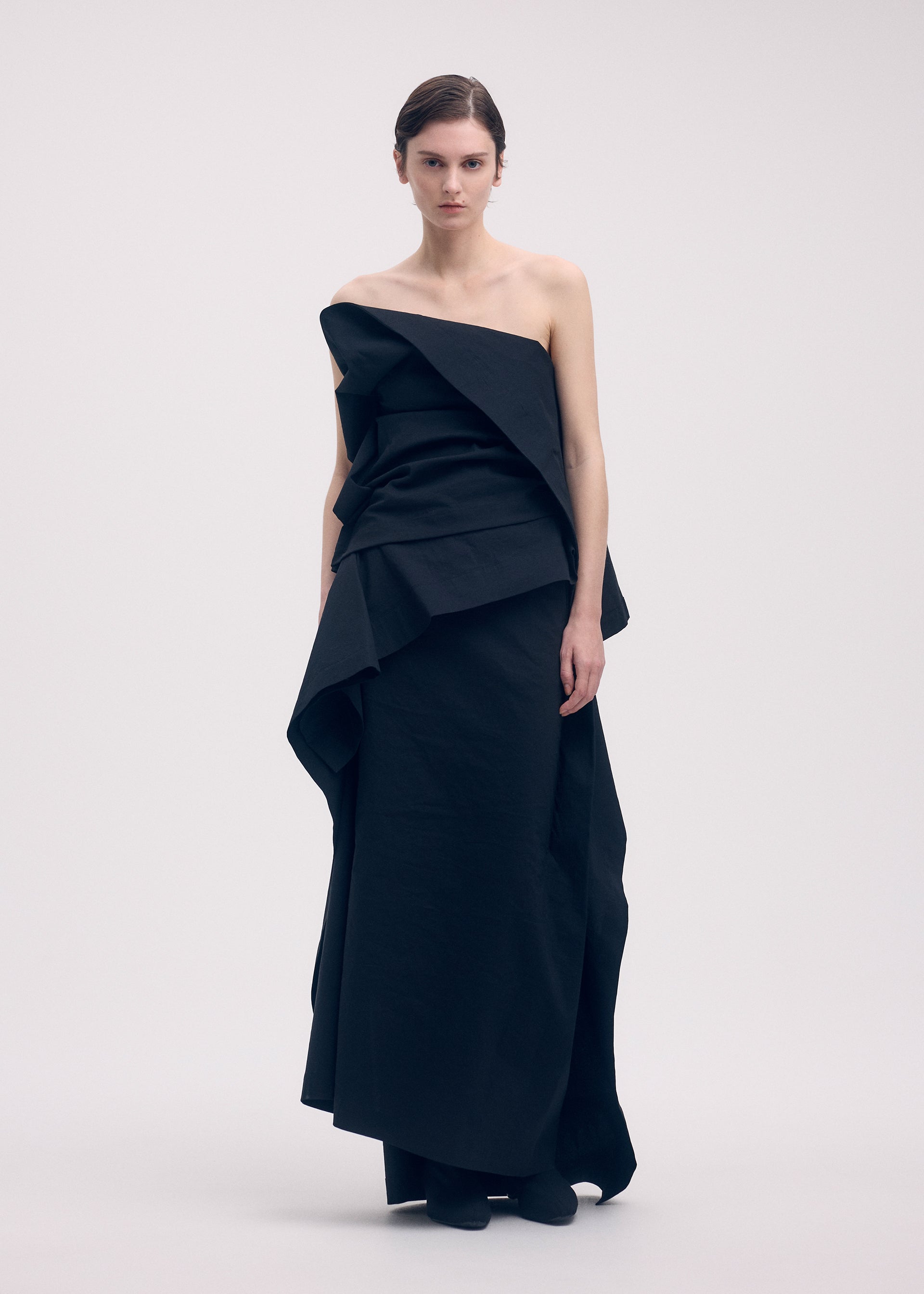 A model wears the ISSEY MIYAKE COLLAPSING SCULPTURE shirt.