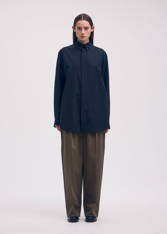 A model wears the ISSEY MIYAKE ODD SHIRT shirt.