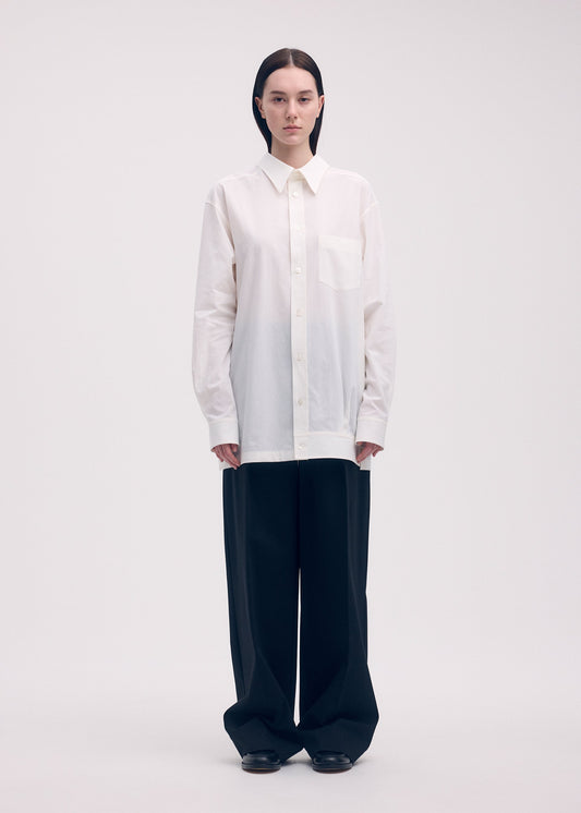 A model wears the ISSEY MIYAKE ODD SHIRT shirt.