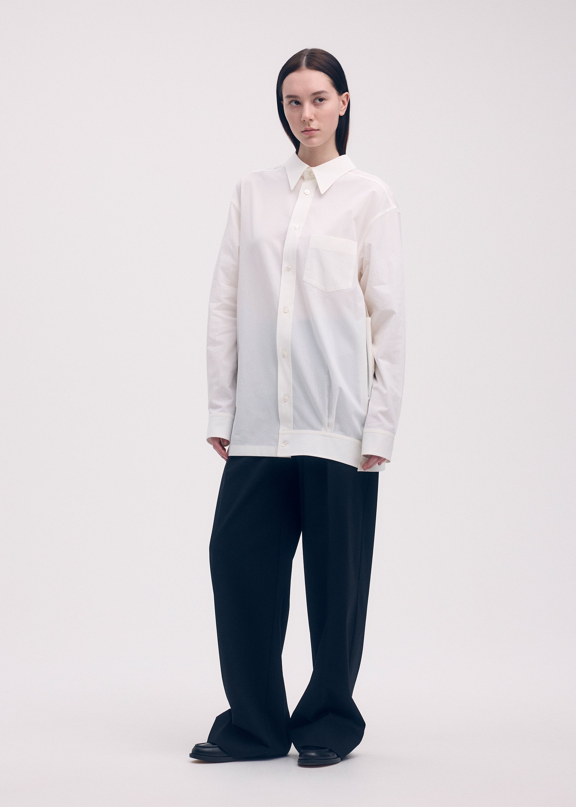 A model wears the ISSEY MIYAKE ODD SHIRT shirt.