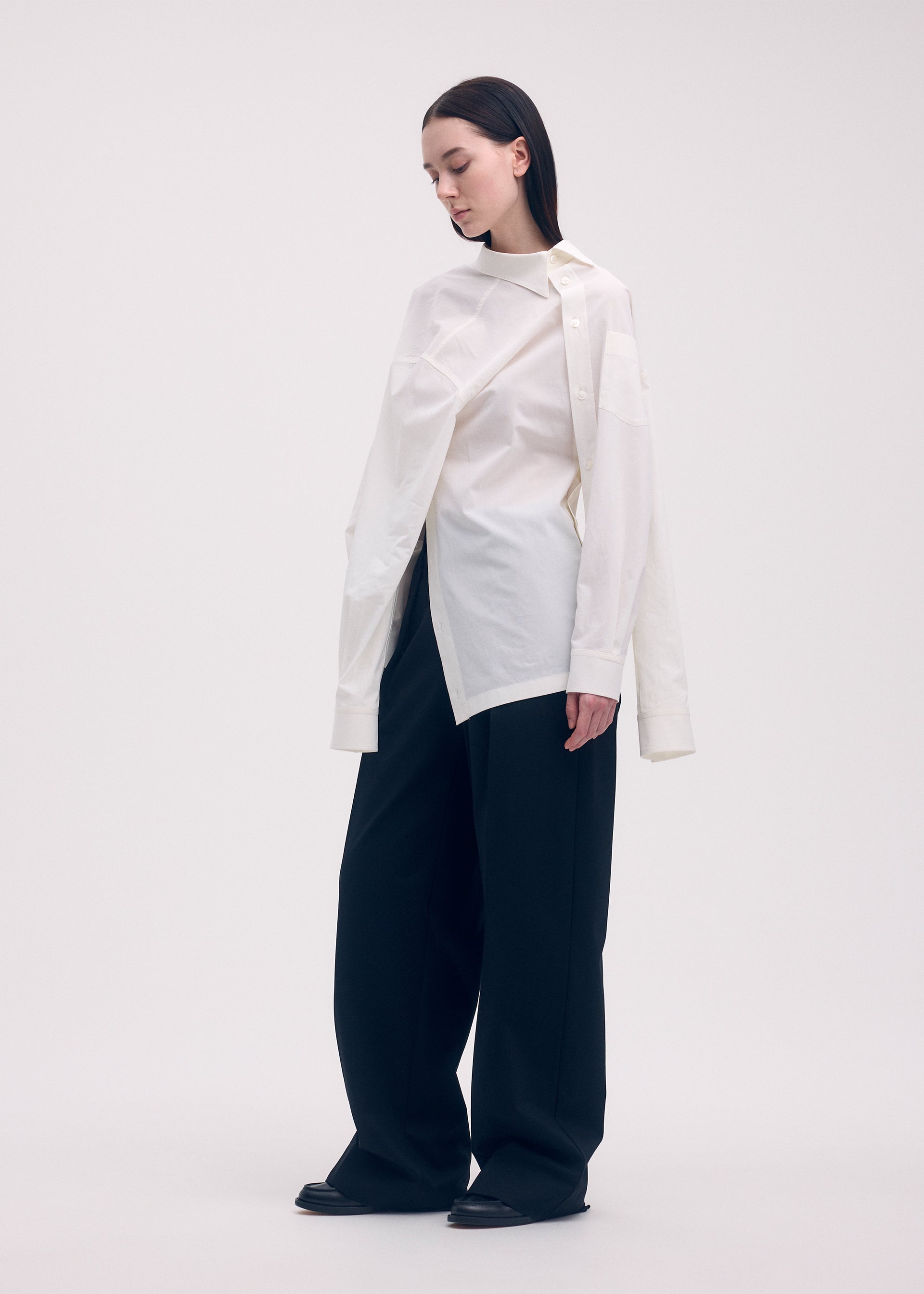 A model wears the ISSEY MIYAKE ODD SHIRT shirt.