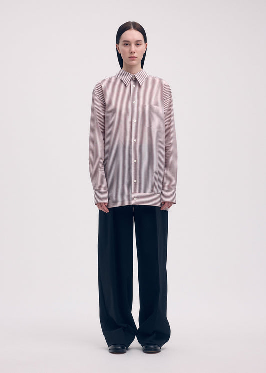 A model wears the ISSEY MIYAKE ODD SHIRT (STRIPES) shirt.