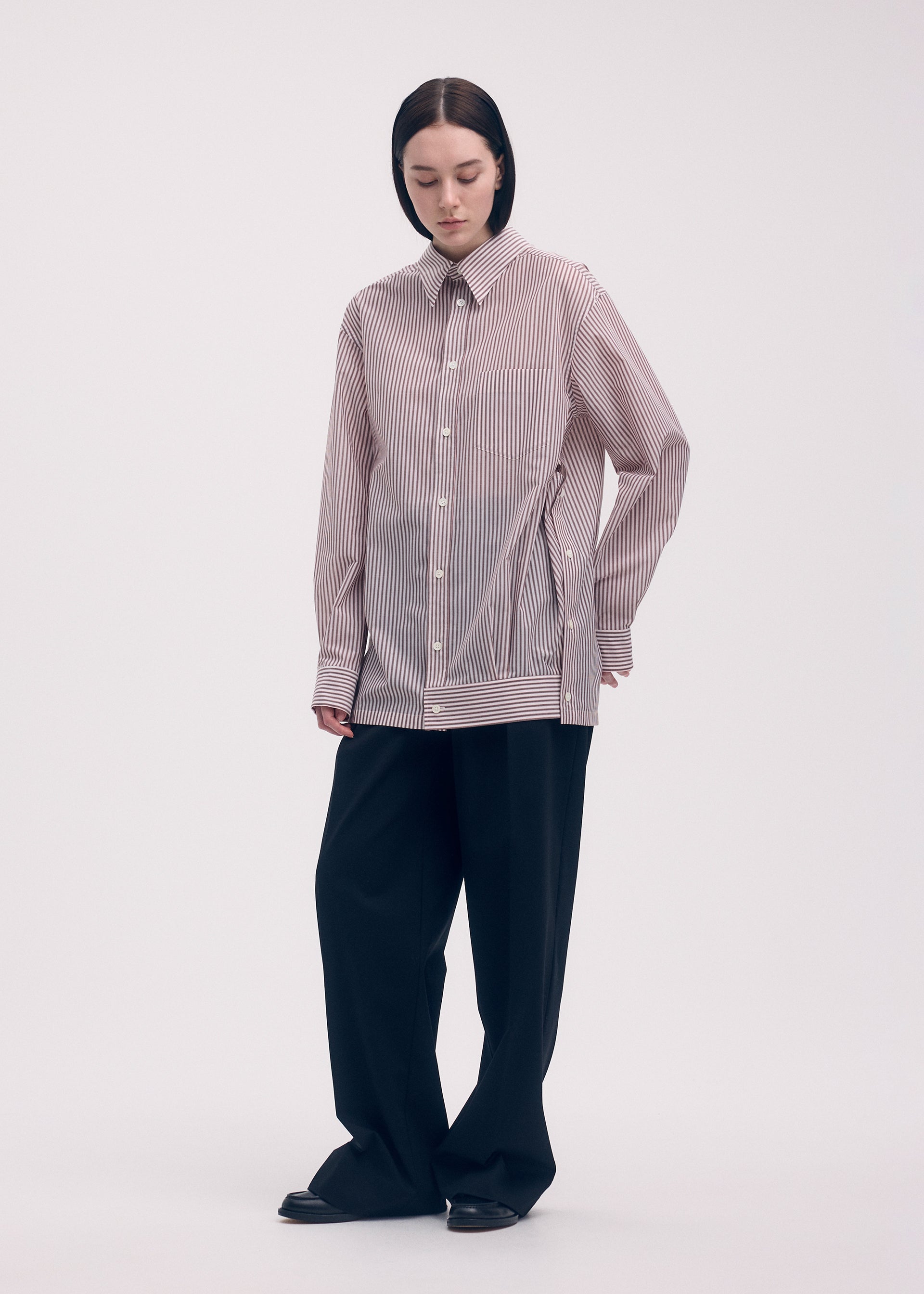 A model wears the ISSEY MIYAKE ODD SHIRT (STRIPES) shirt.