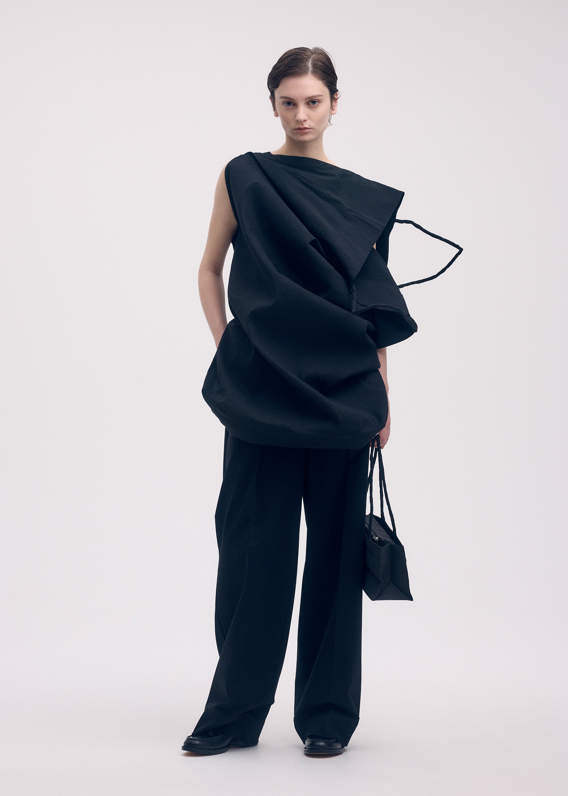 A model wears the ISSEY MIYAKE PAPER BAG shirt.