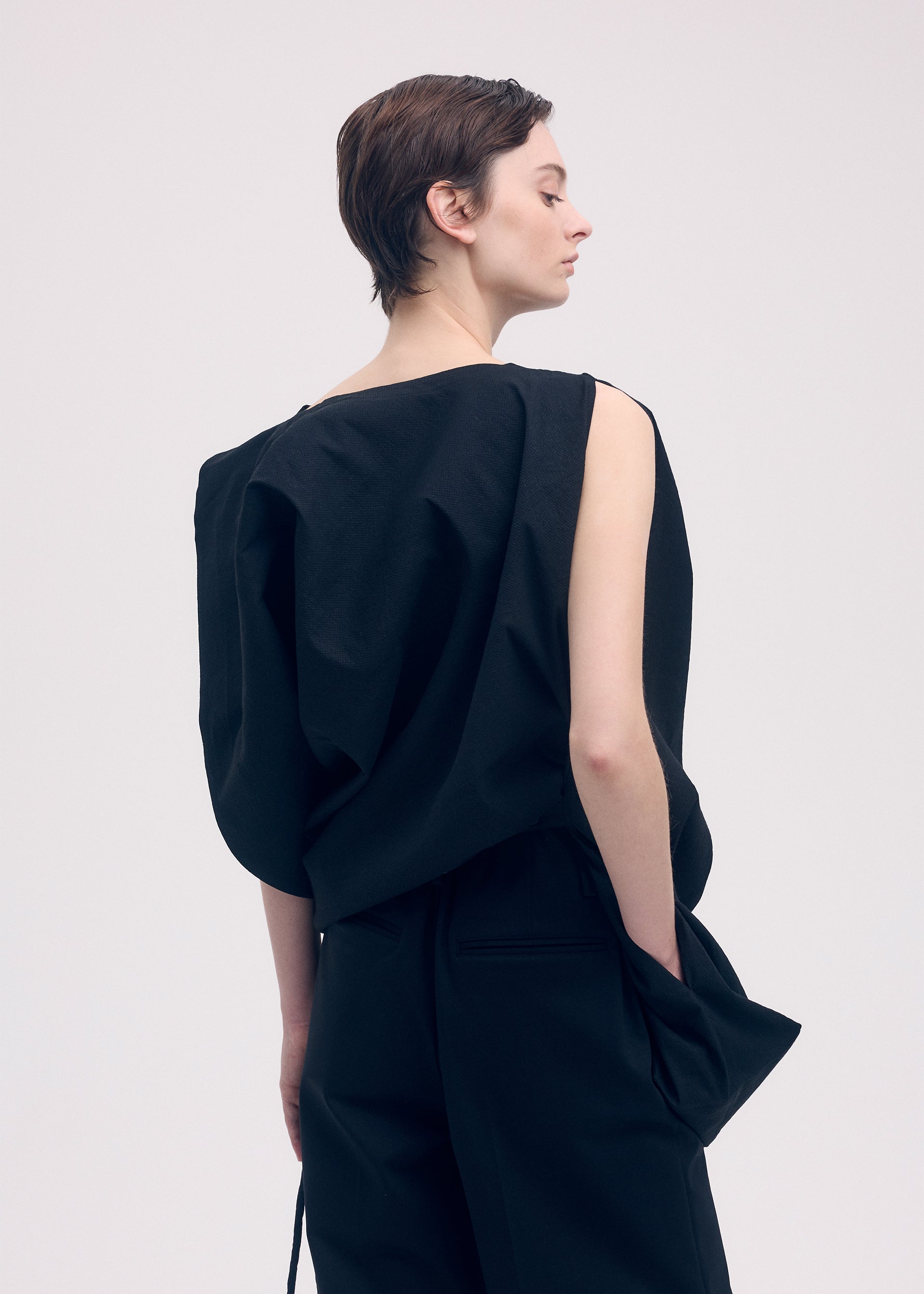A model wears the ISSEY MIYAKE PAPER BAG shirt.