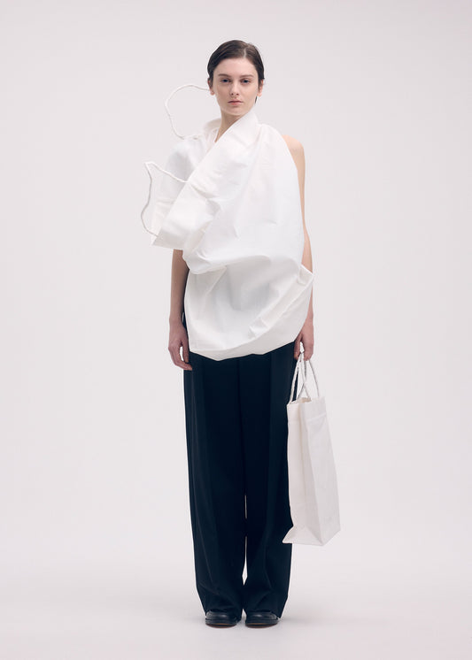 A model wears the ISSEY MIYAKE PAPER BAG shirt.