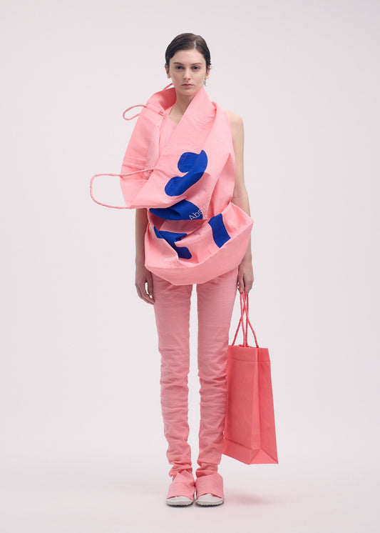 A model wears the ISSEY MIYAKE PAPER BAG (POSTER) shirt.
