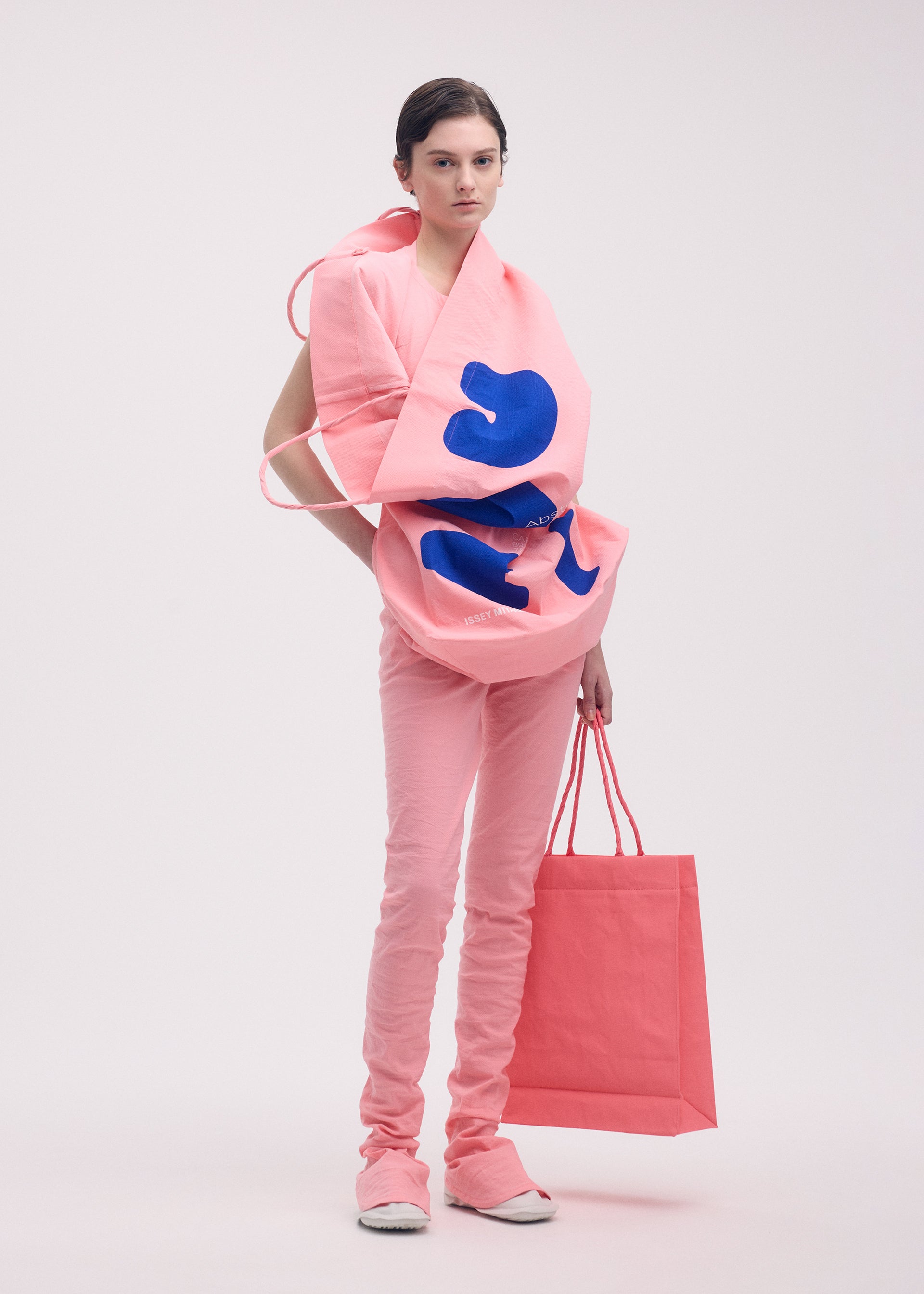 A model wears the ISSEY MIYAKE PAPER BAG (POSTER) shirt.