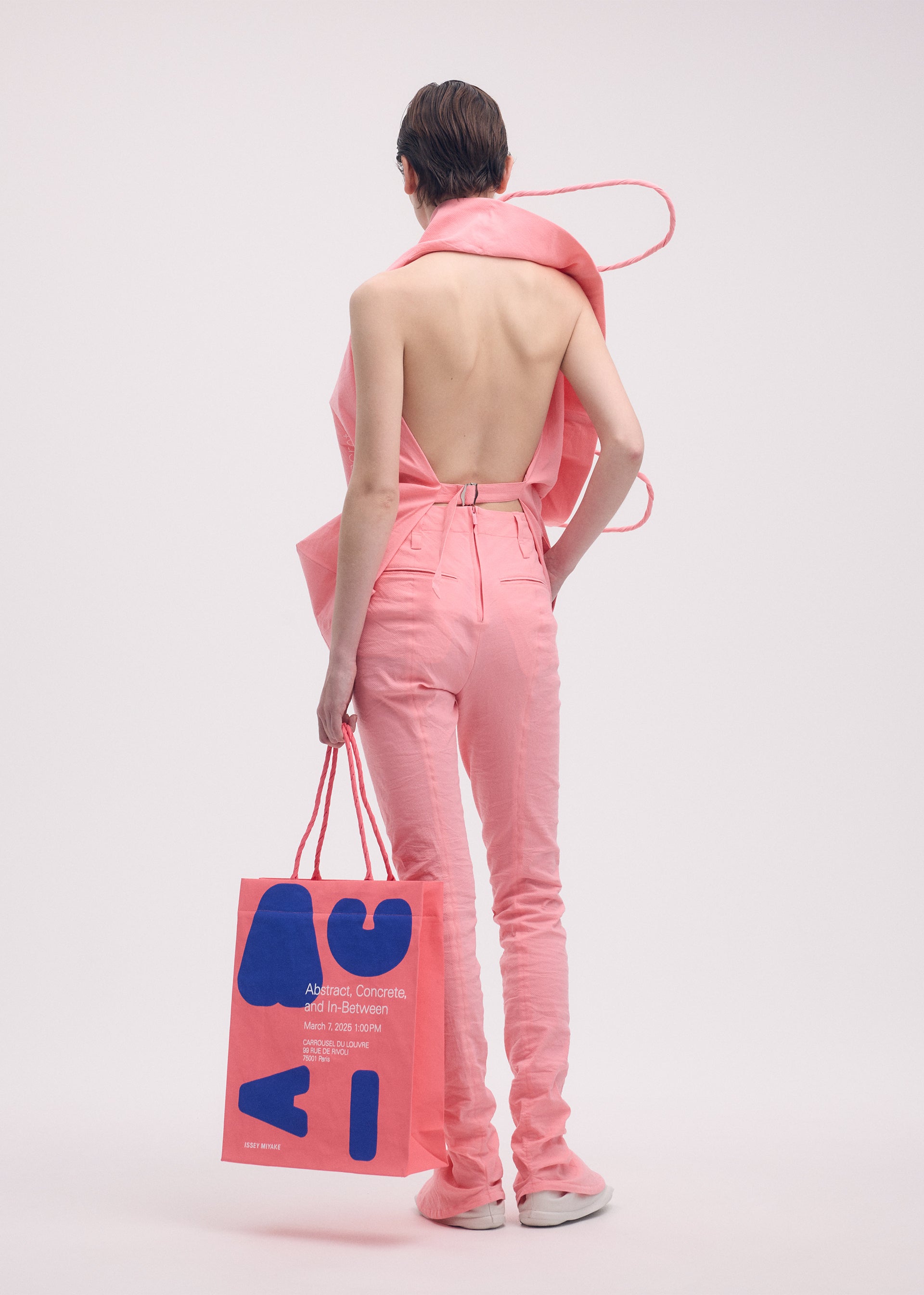 A model wears the ISSEY MIYAKE PAPER BAG (POSTER) shirt.