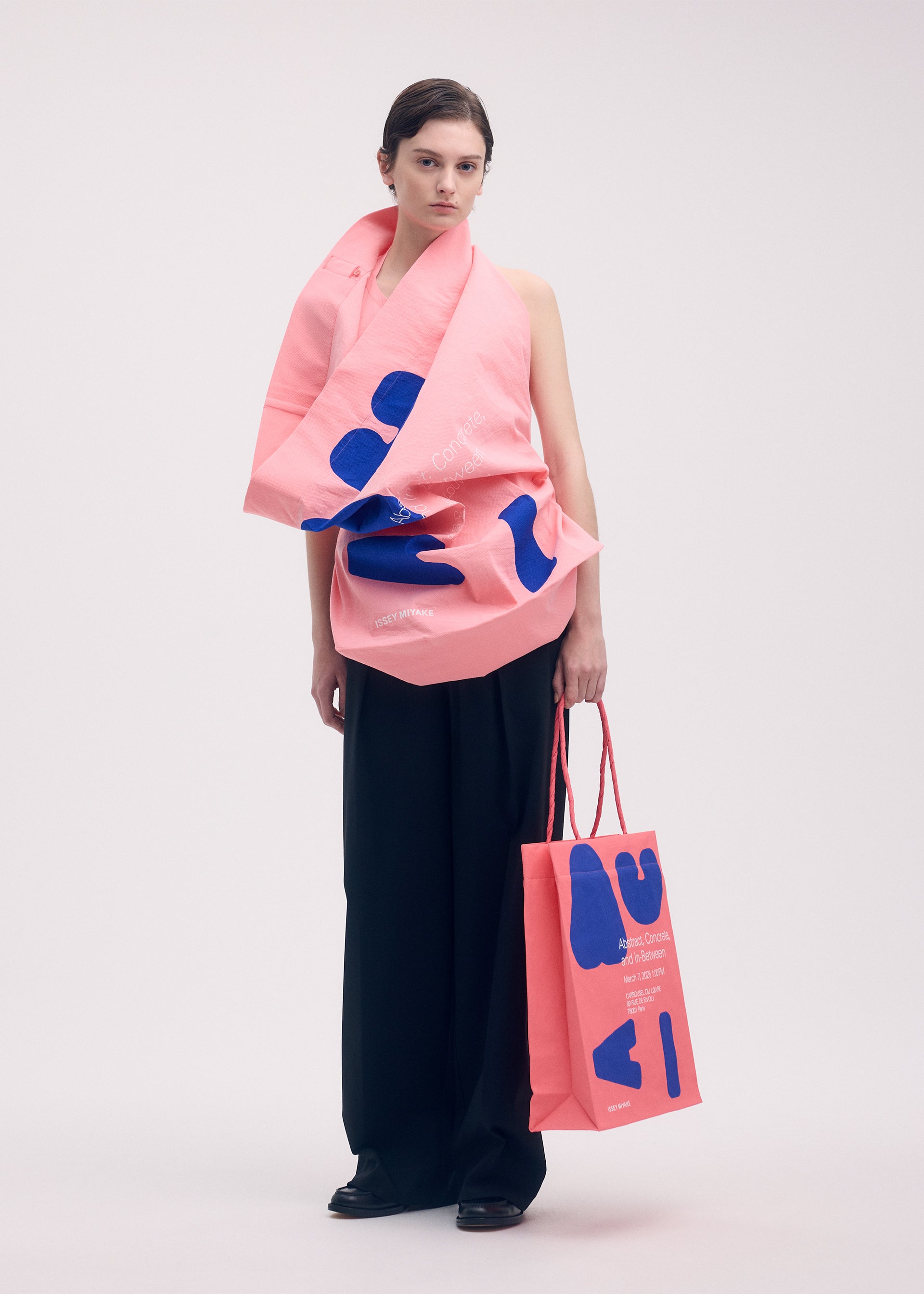 A model wears the ISSEY MIYAKE PAPER BAG (POSTER) shirt.