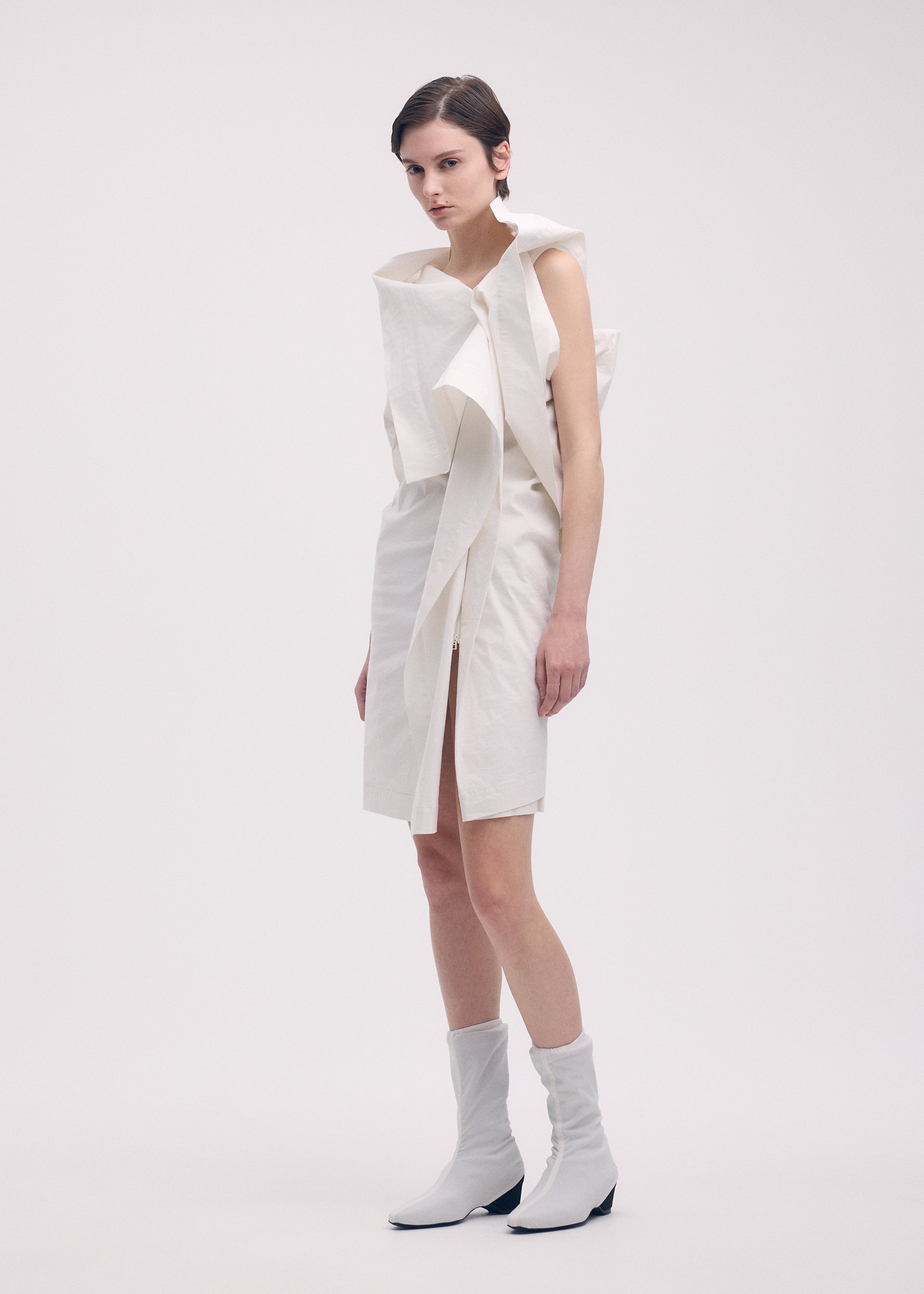 A model wears the ISSEY MIYAKE COLLAPSING SCULPTURE tunic.