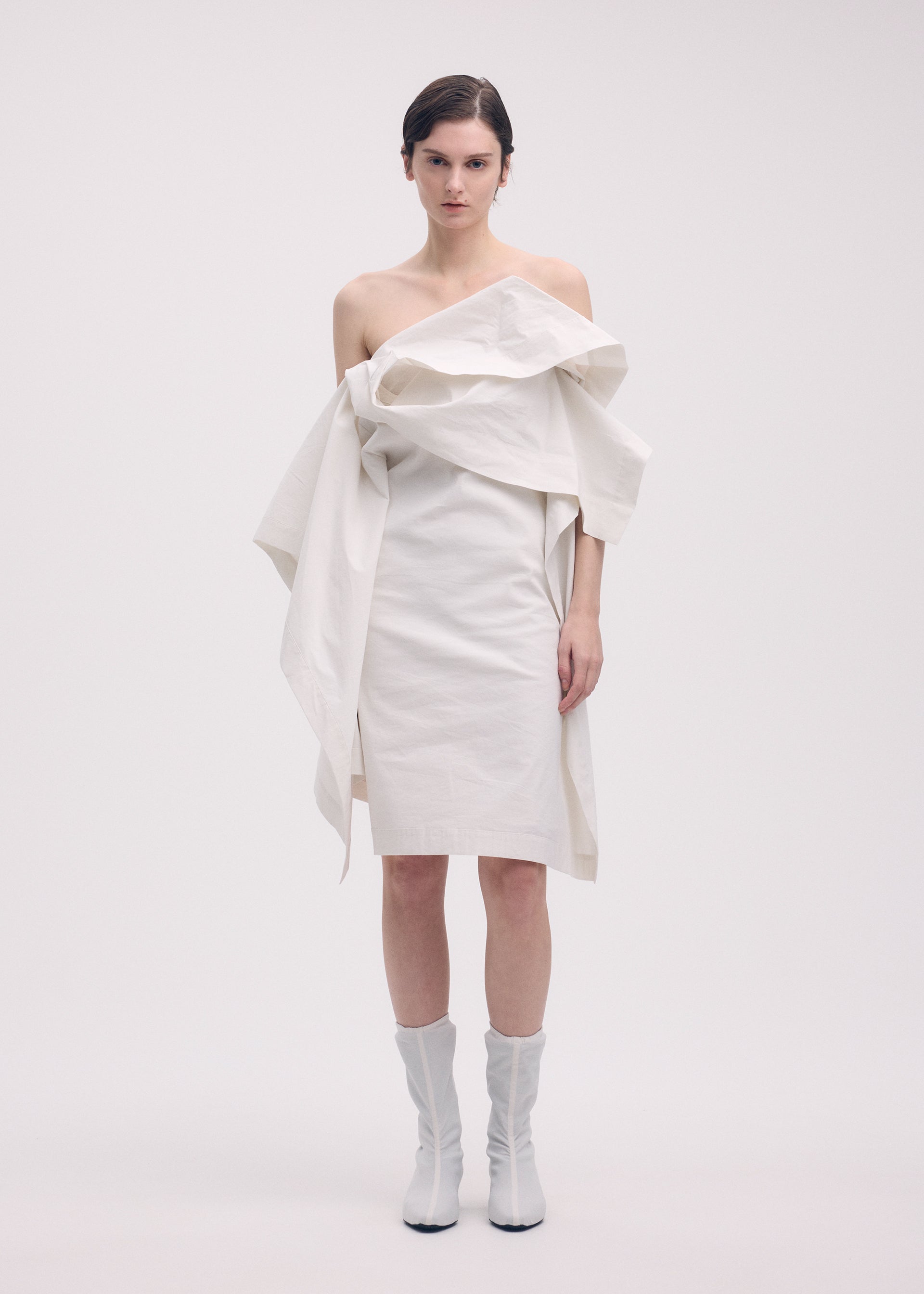 A model wears the ISSEY MIYAKE COLLAPSING SCULPTURE tunic.