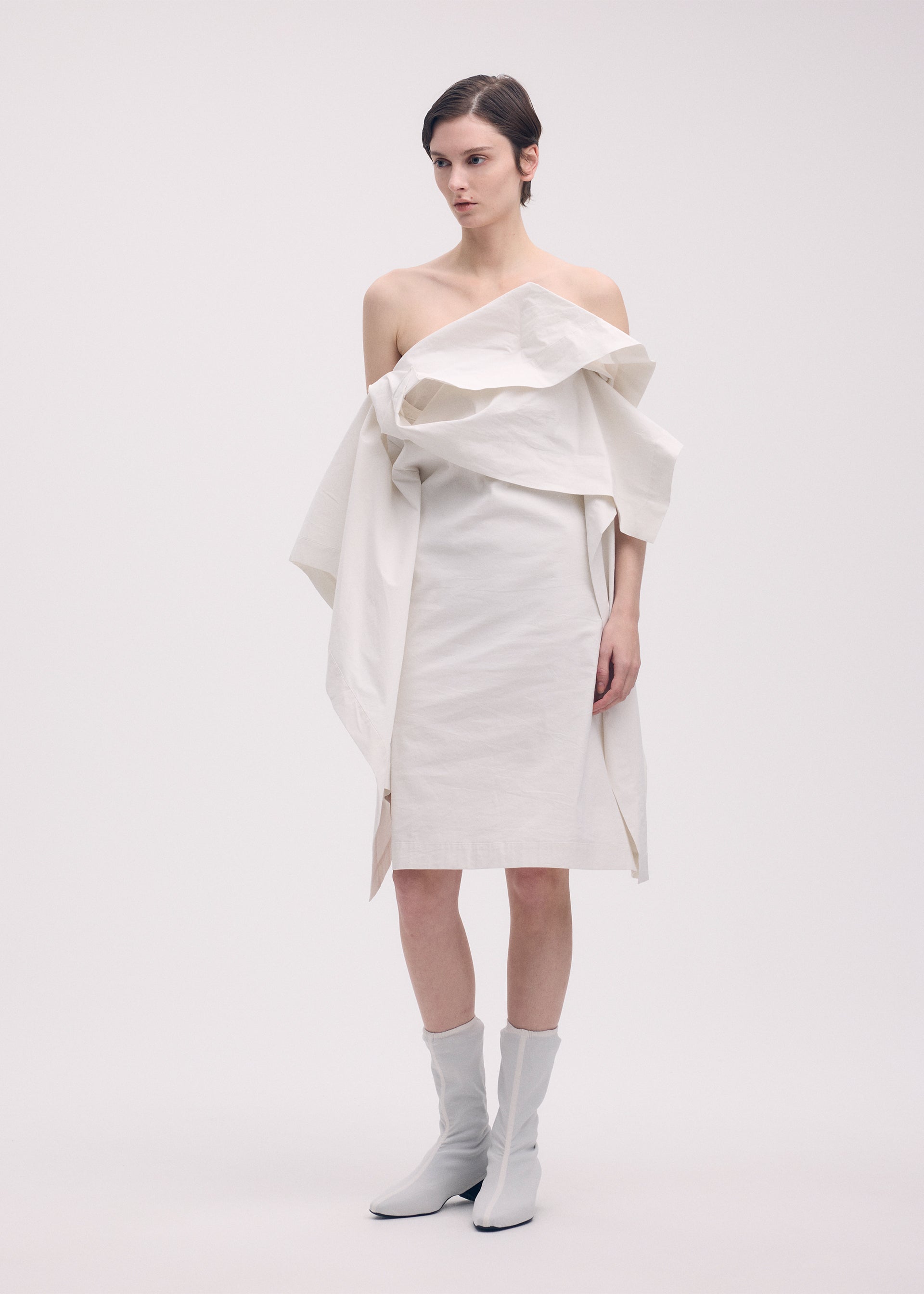 A model wears the ISSEY MIYAKE COLLAPSING SCULPTURE tunic.