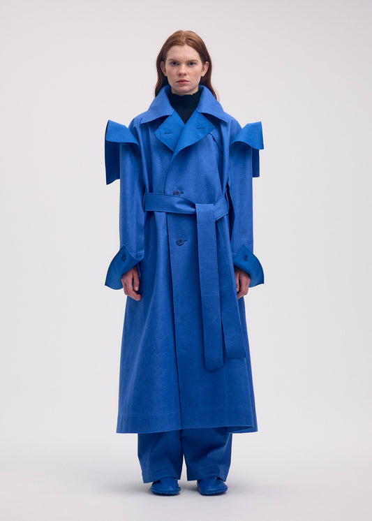 A model wears the ISSEY MIYAKE LEFT UNDONE coat.