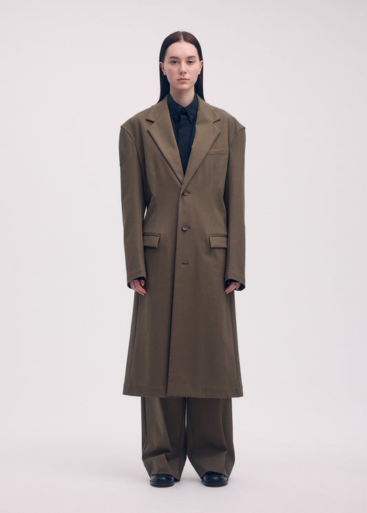 A model wears the ISSEY MIYAKE SIMPLE ENSEMBLE jacket.