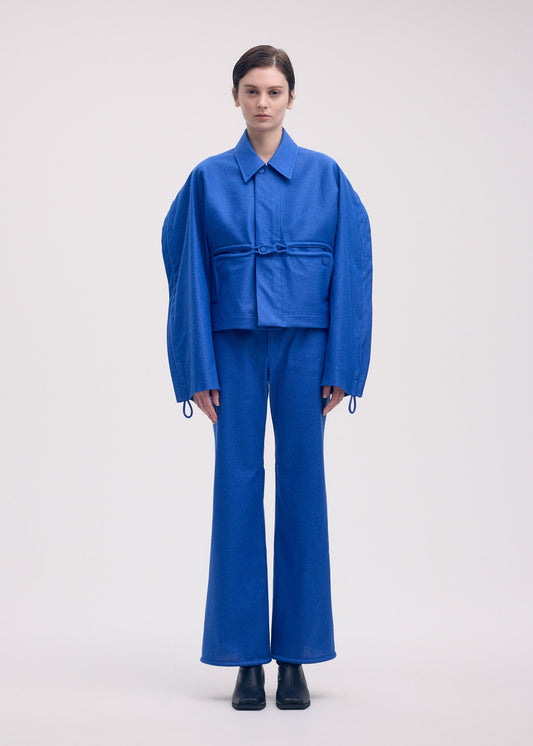 A model wears the ISSEY MIYAKE HANG OR CARRY jacket.