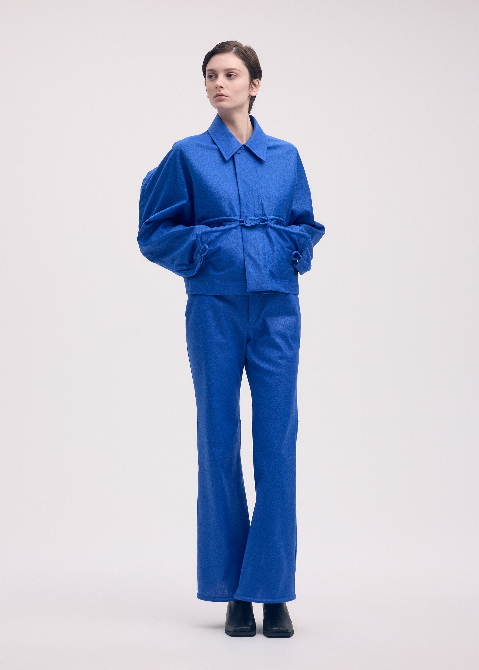 A model wears the ISSEY MIYAKE HANG OR CARRY jacket.