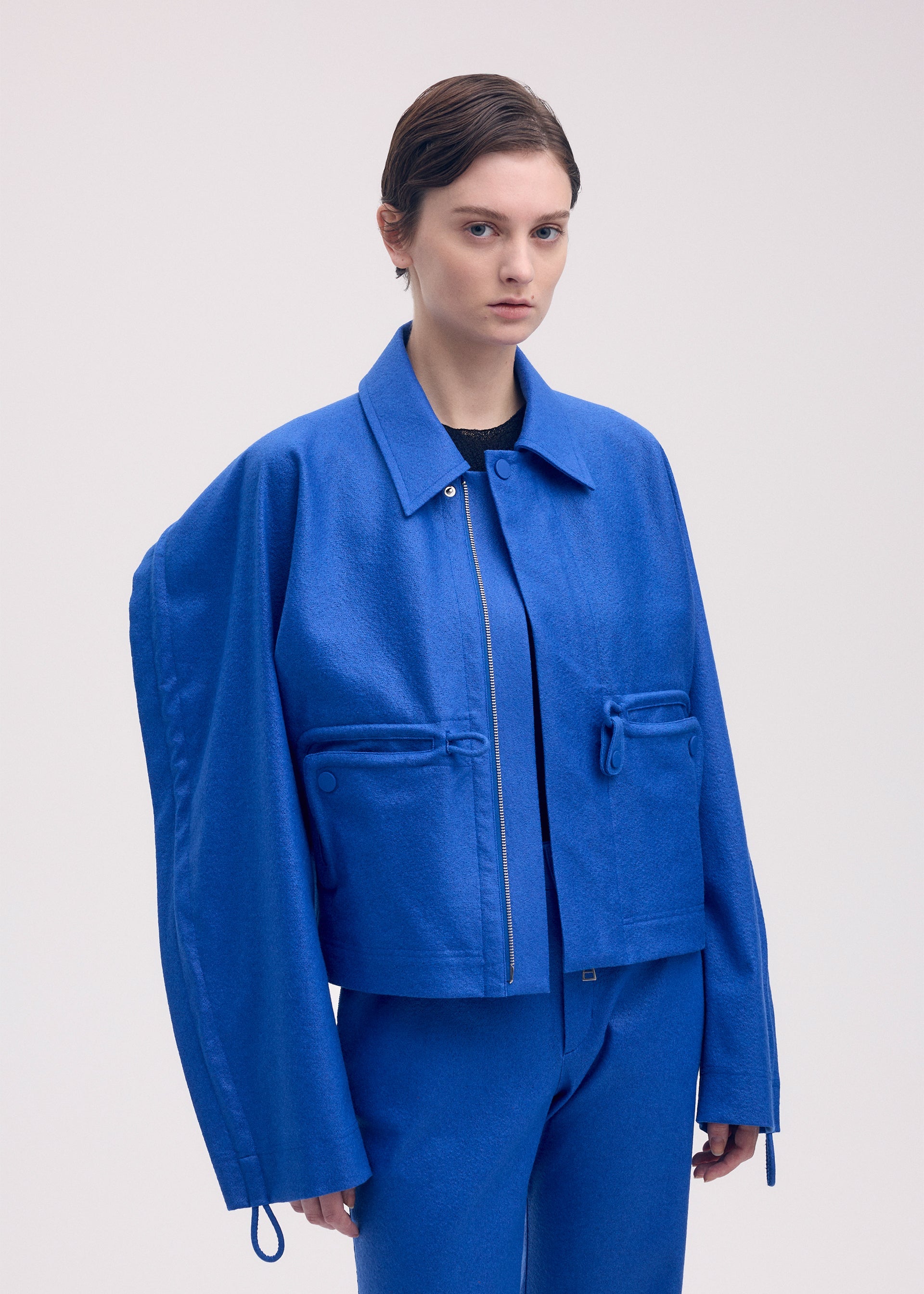 A model wears the ISSEY MIYAKE HANG OR CARRY jacket.