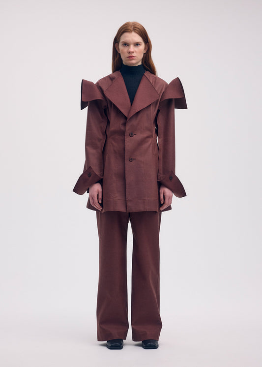 A model wears the ISSEY MIYAKE LEFT UNDONE jacket.