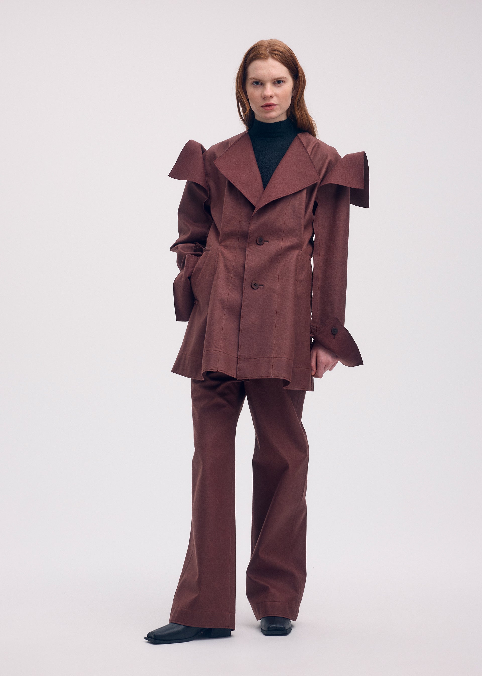 A model wears the ISSEY MIYAKE LEFT UNDONE jacket.