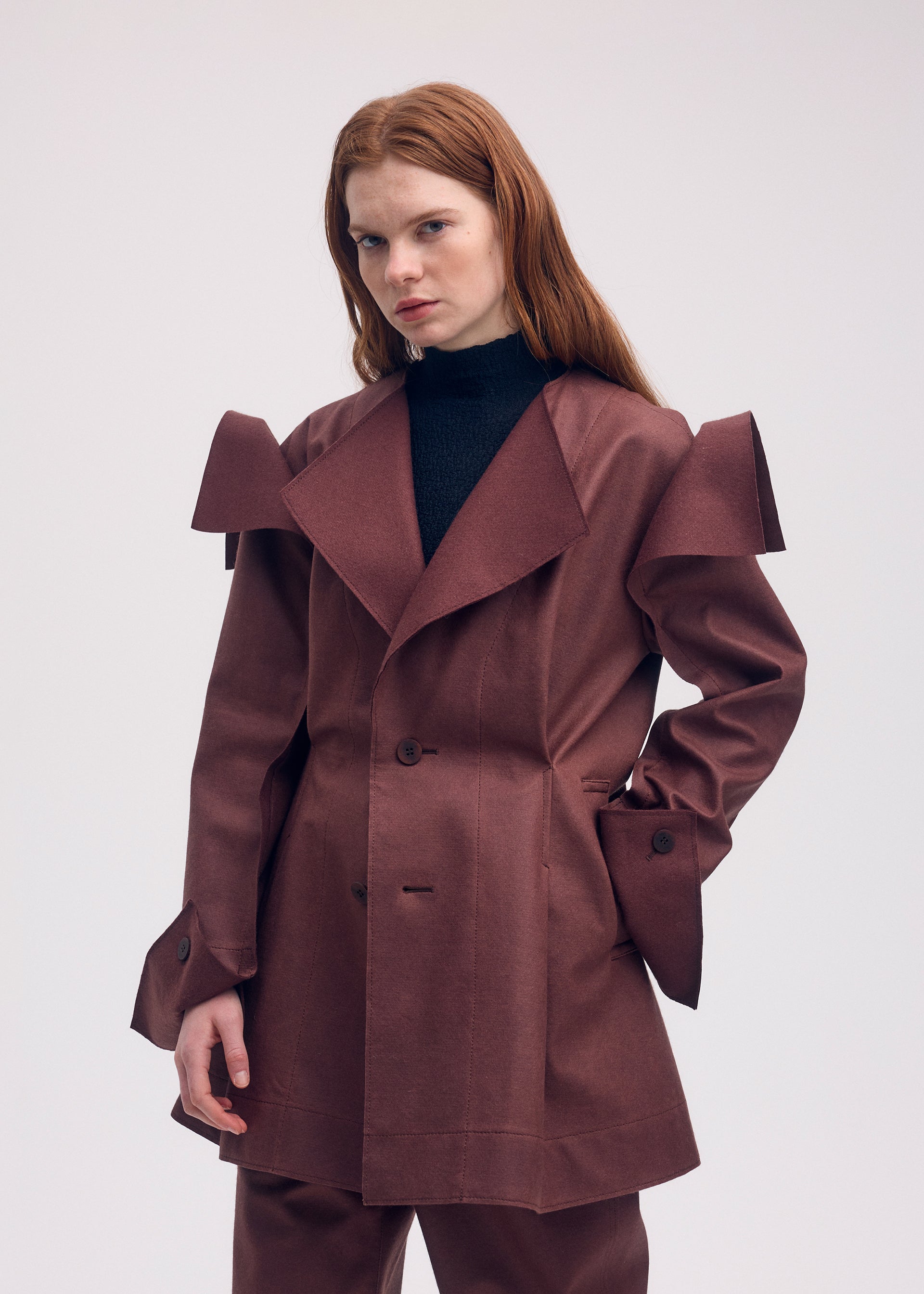 A model wears the ISSEY MIYAKE LEFT UNDONE jacket.
