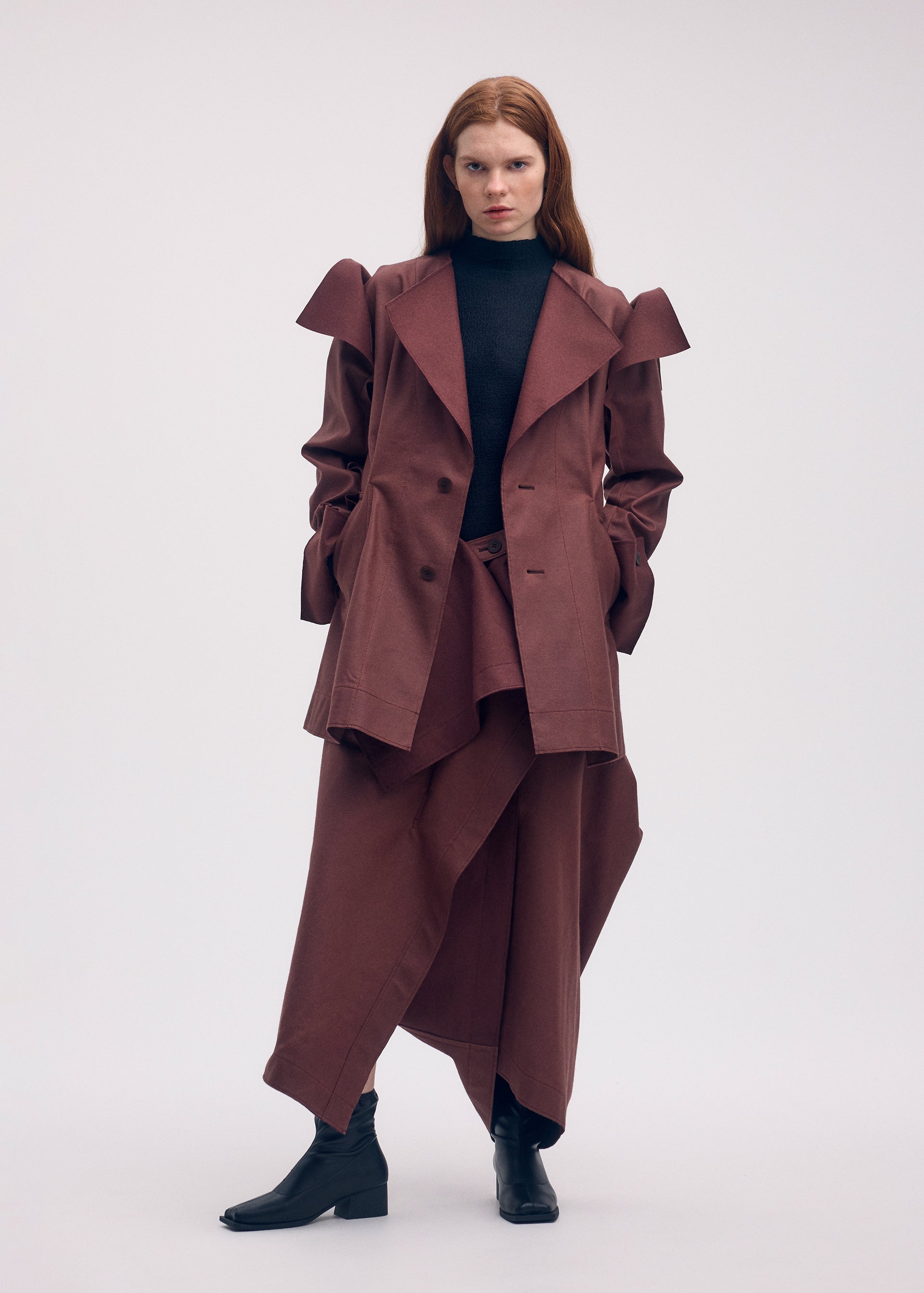 A model wears the ISSEY MIYAKE LEFT UNDONE jacket.