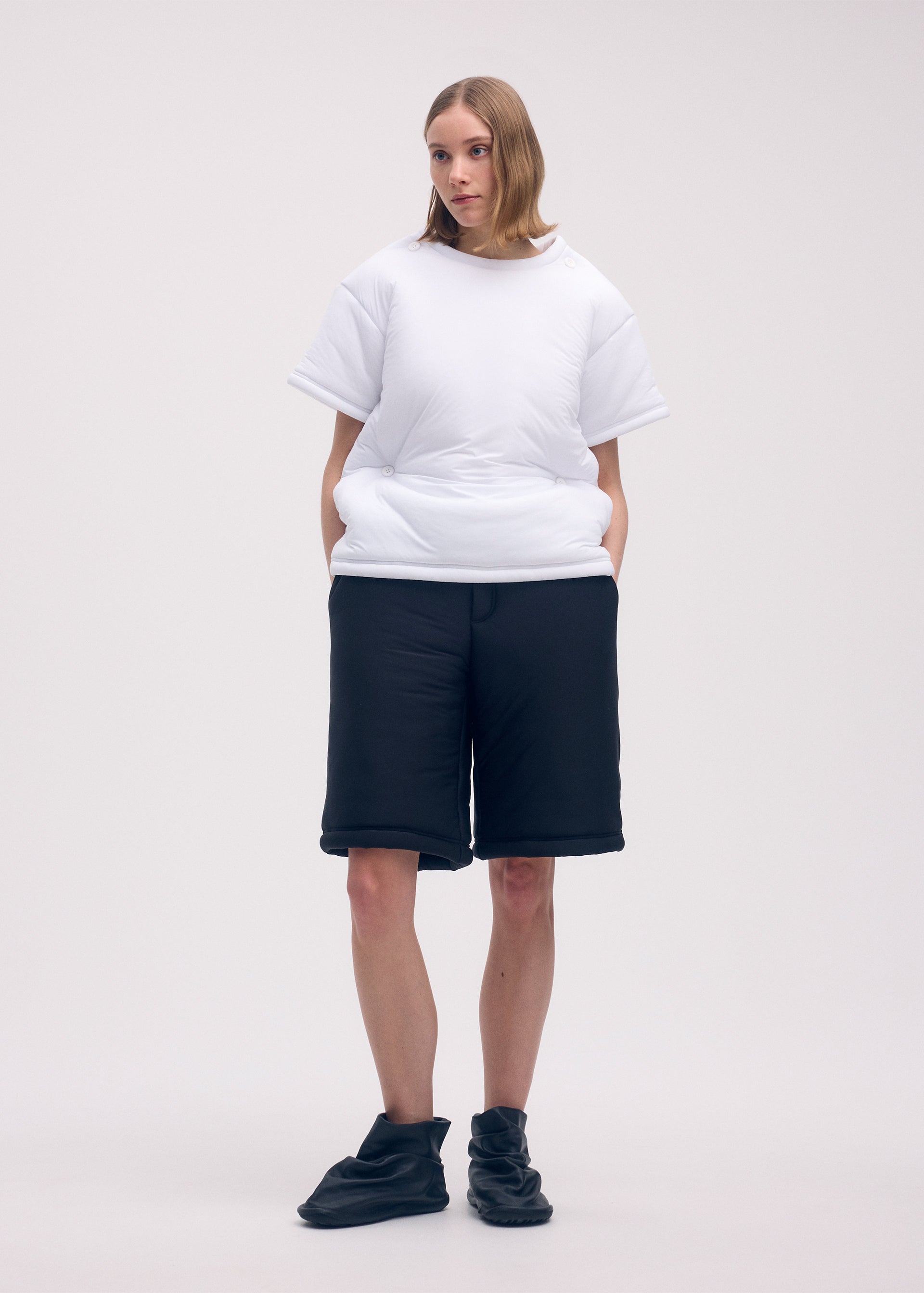 A model wears the ISSEY MIYAKE PUMPED T trousers.