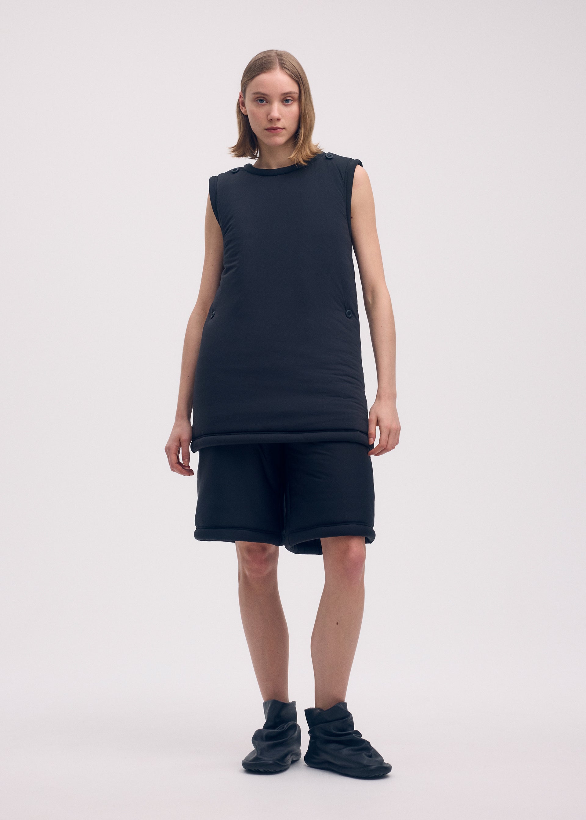 A model wears the ISSEY MIYAKE PUMPED T trousers.