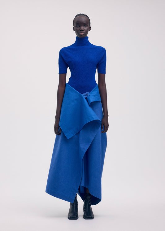 A model wears the ISSEY MIYAKE LEFT UNDONE trousers.