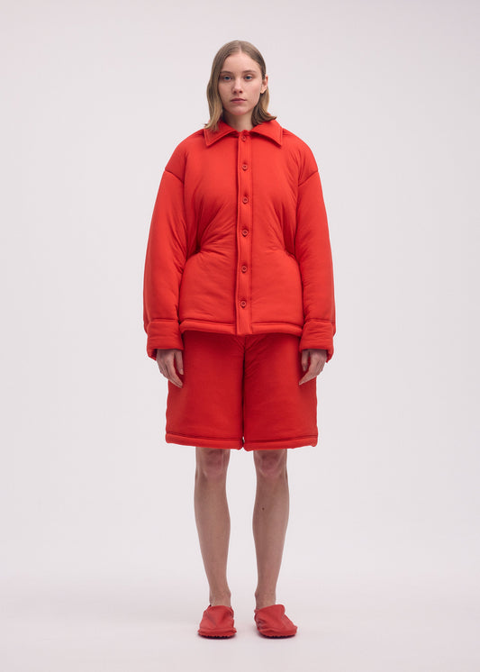 A model wears the ISSEY MIYAKE PUMPED T shirt.