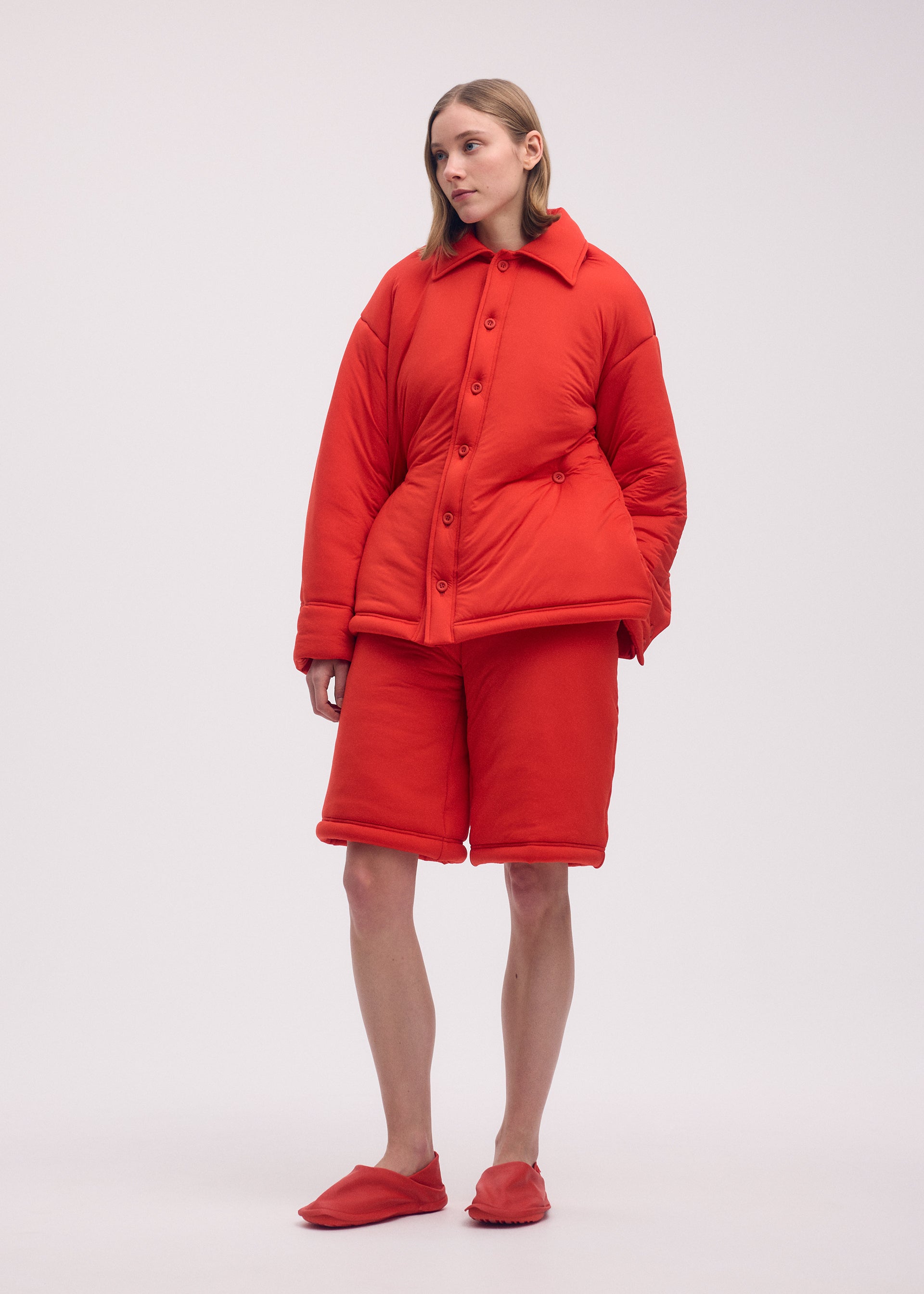 A model wears the ISSEY MIYAKE PUMPED T shirt.