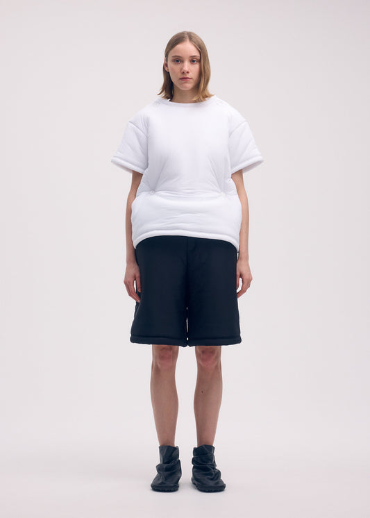 A model wears the ISSEY MIYAKE PUMPED T top.