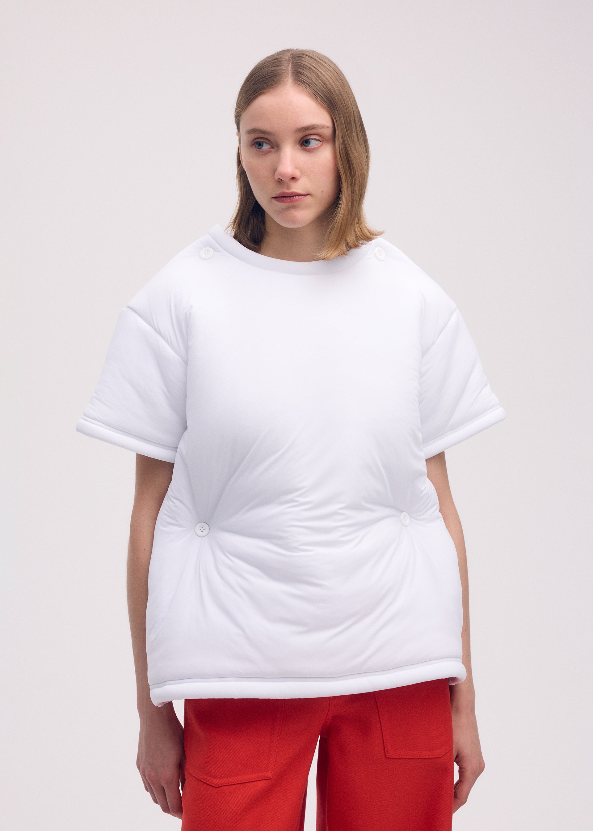 A model wears the ISSEY MIYAKE PUMPED T top.