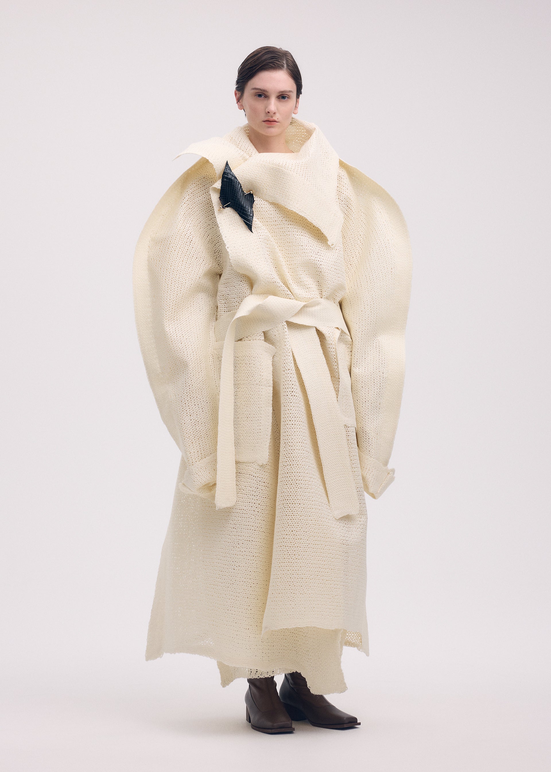 A model wears the ISSEY MIYAKE PANINI coat.