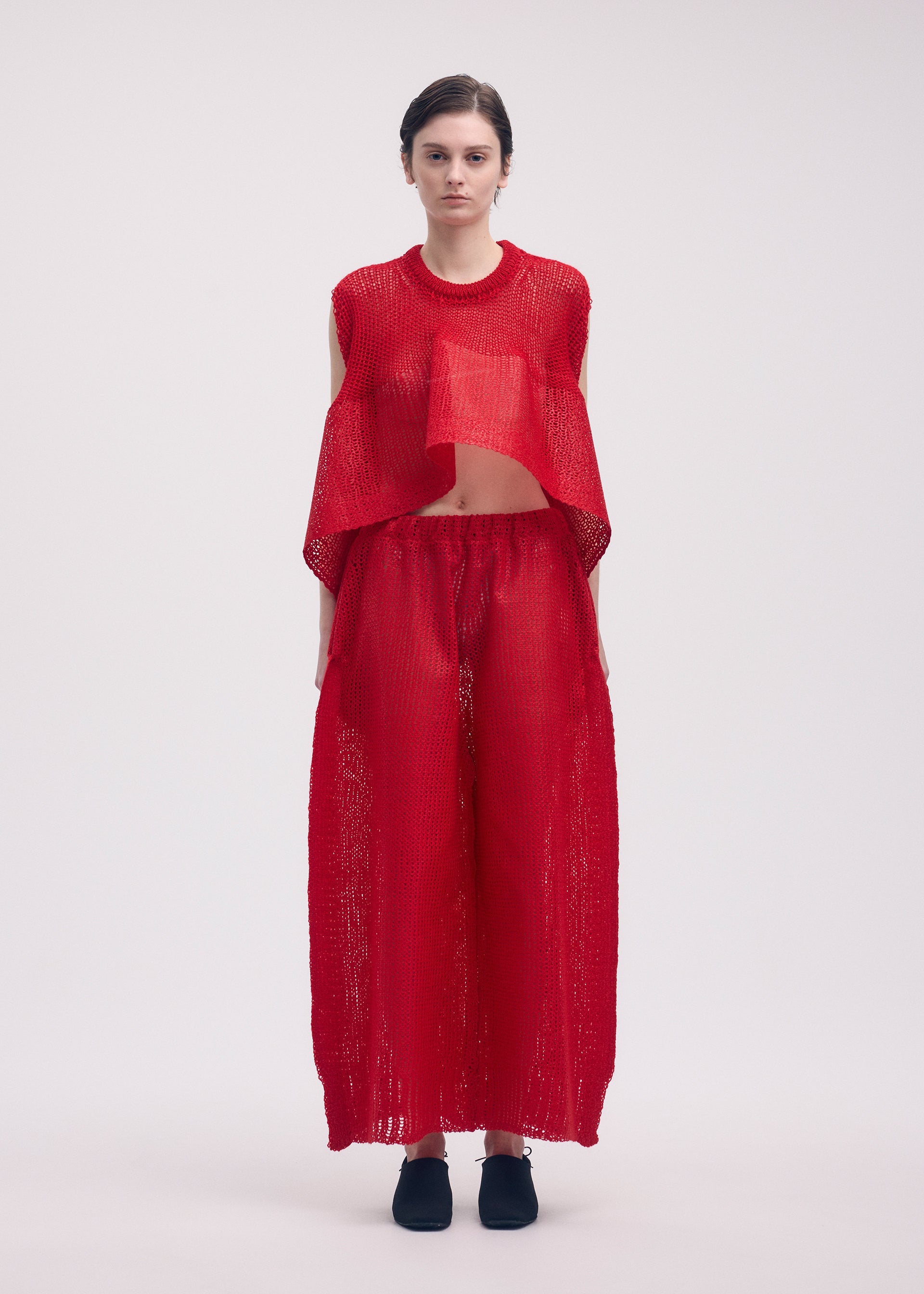 A model wears the ISSEY MIYAKE PANINI trousers.