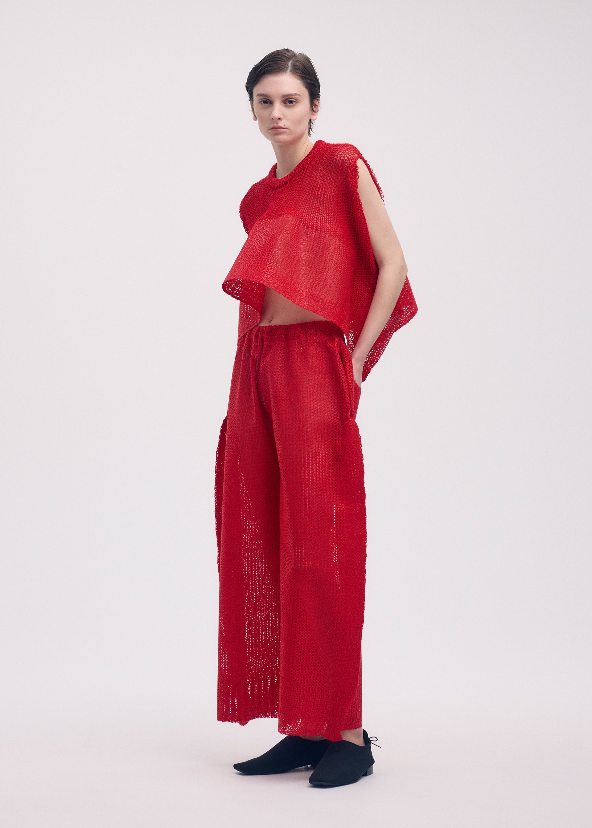 A model wears the ISSEY MIYAKE PANINI trousers.