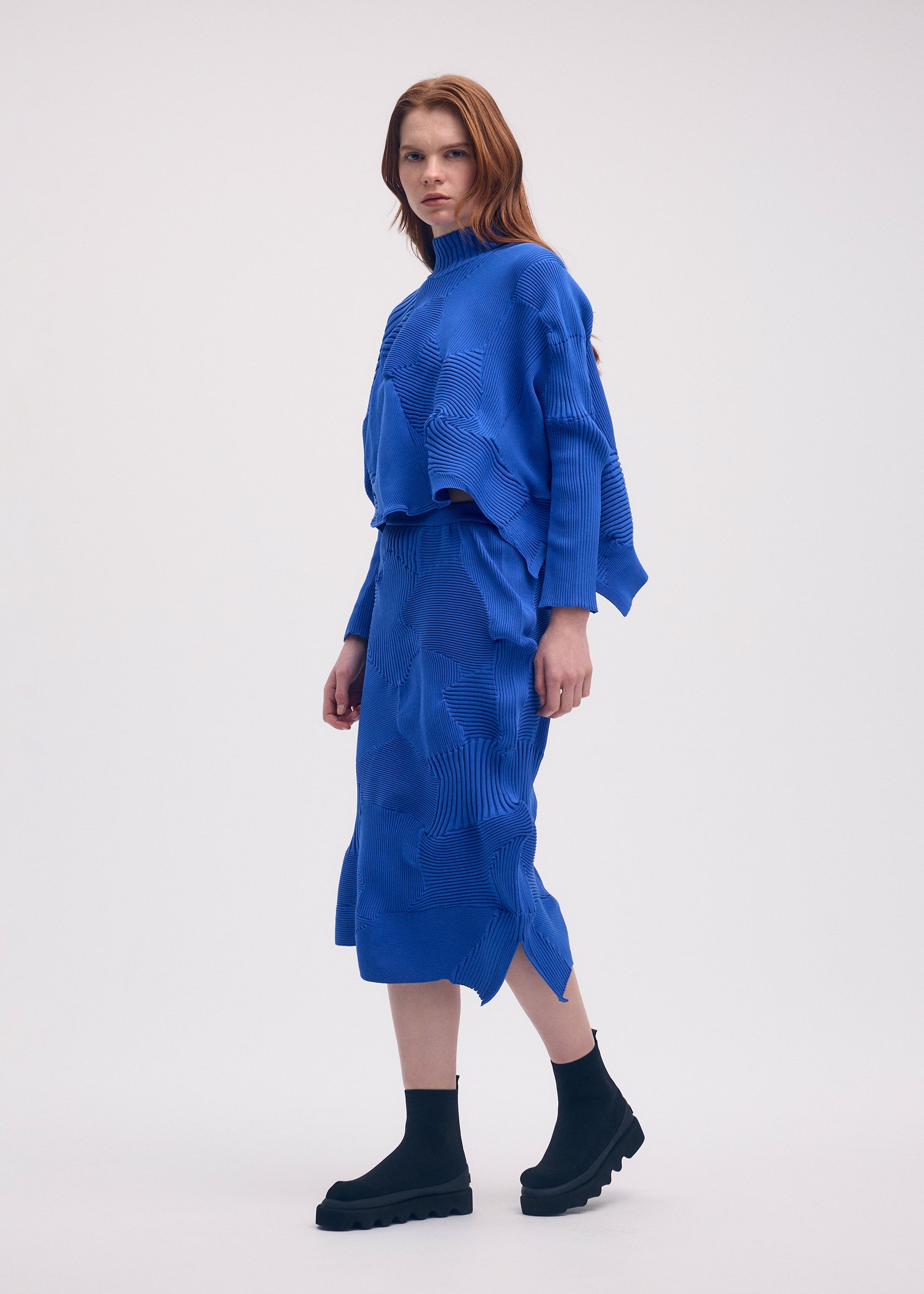 A model wears the ISSEY MIYAKE KONE KONE skirt.
