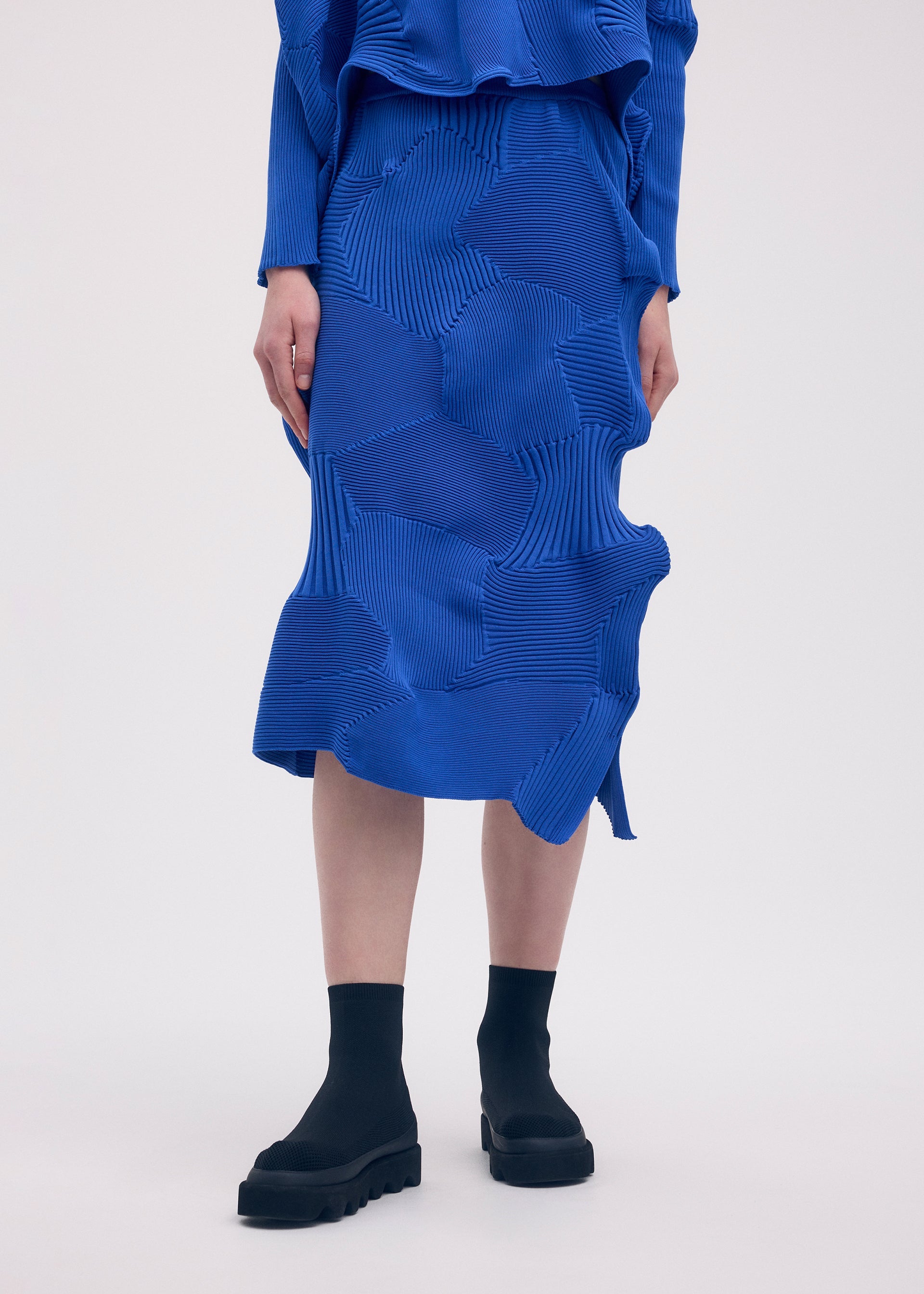 A model wears the ISSEY MIYAKE KONE KONE skirt.