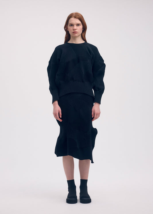 A model wears the ISSEY MIYAKE KONE KONE top.