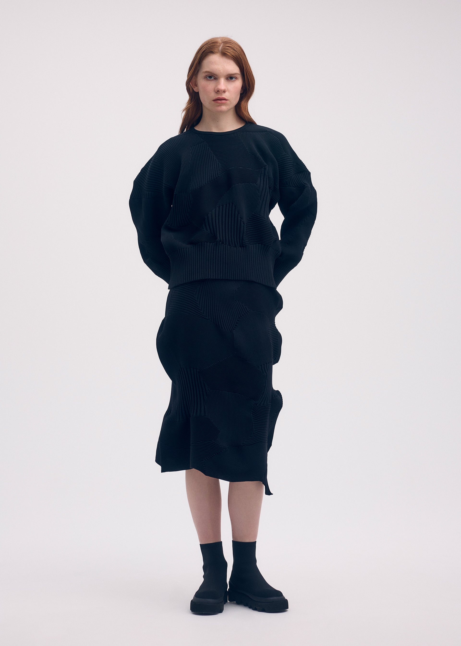 A model wears the ISSEY MIYAKE KONE KONE top.