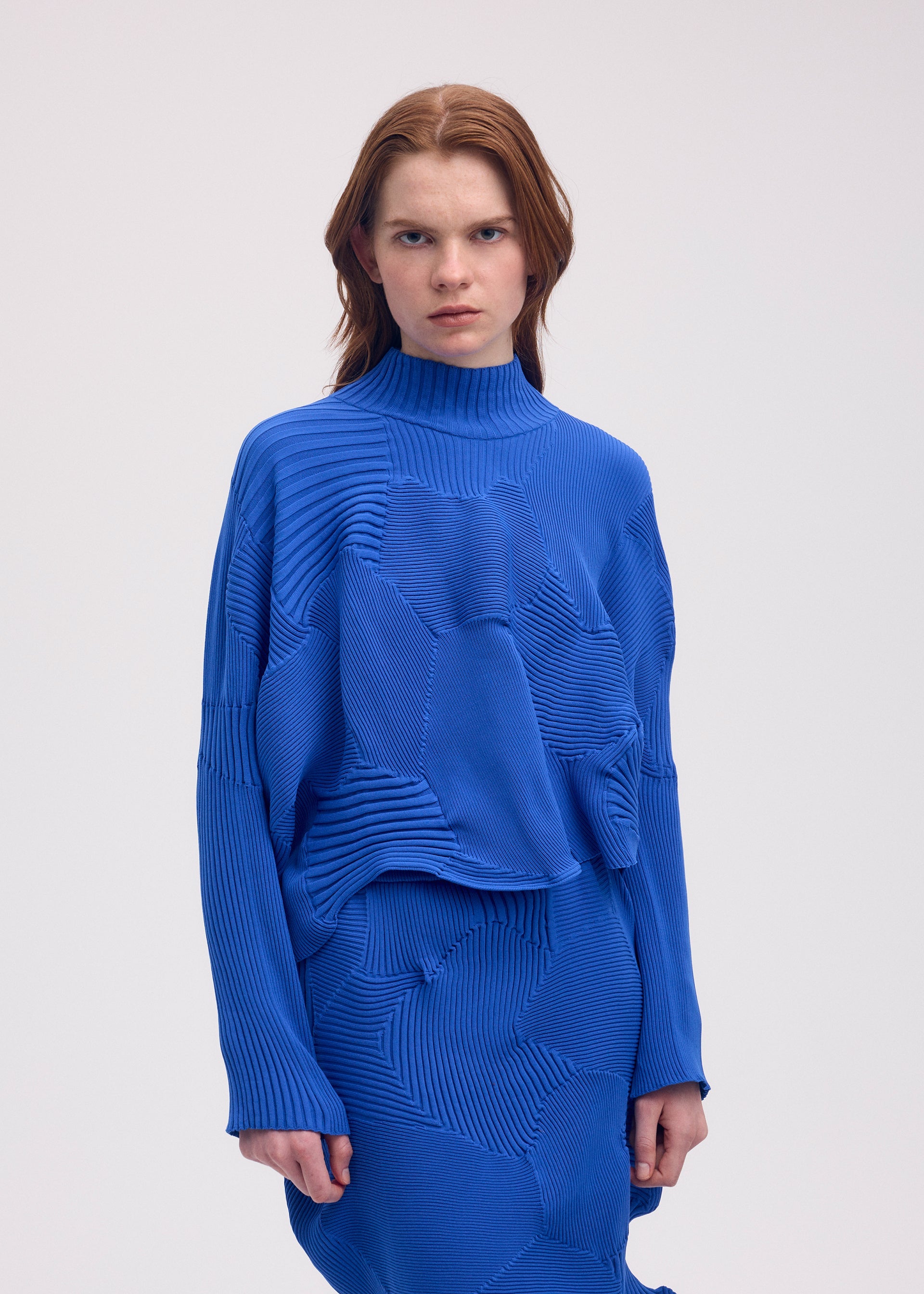 A model wears the ISSEY MIYAKE KONE KONE top.