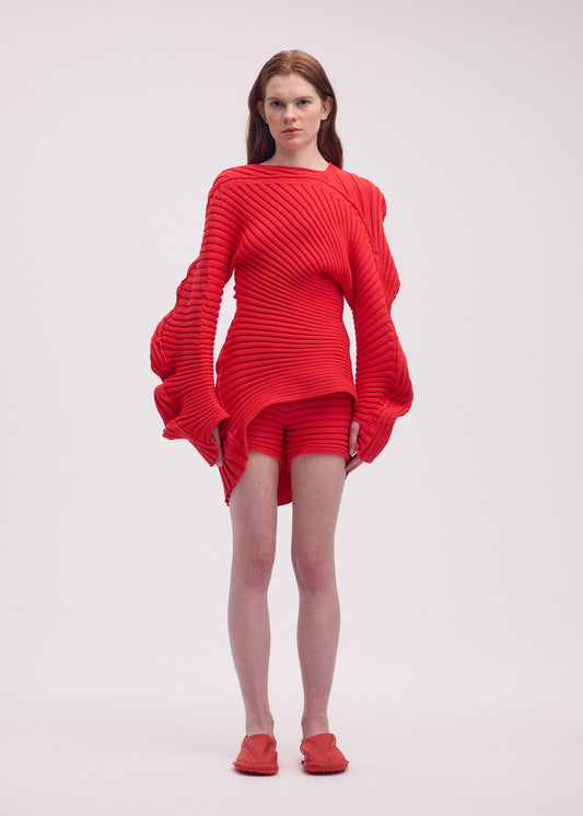 A model wears the ISSEY MIYAKE KNIT (AS IT IS) top.