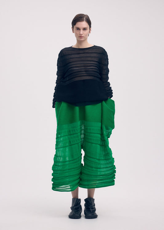 A model wears the ISSEY MIYAKE MOVING KNIT clothing.