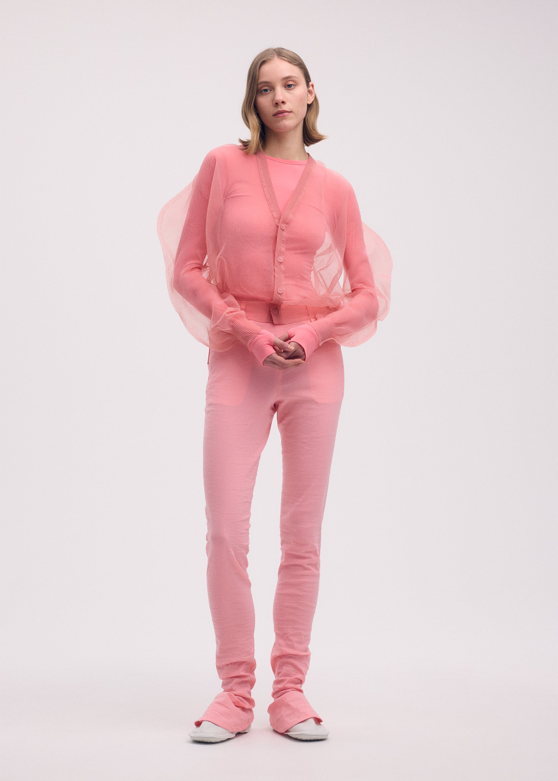 A model wears the ISSEY MIYAKE ENCASE cardigan.